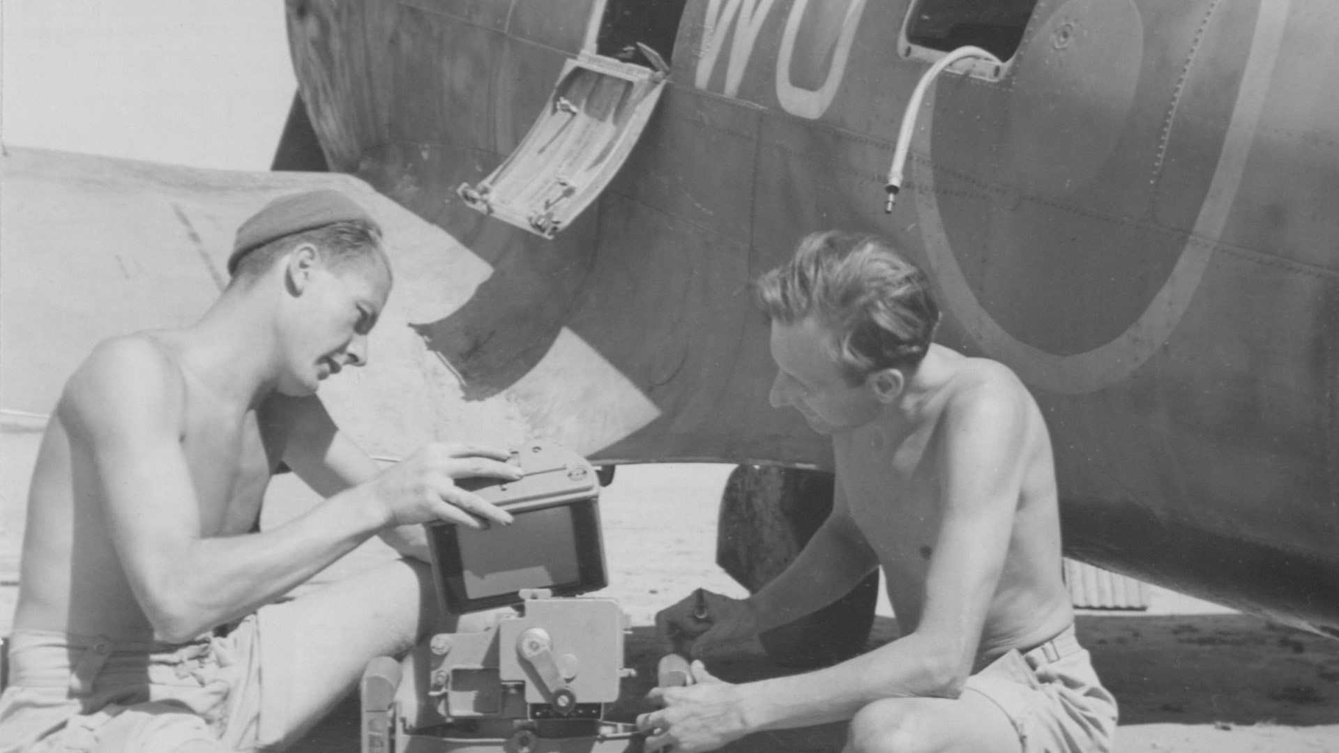 A camera being changed on a Spitfire in Italy during World War II.
