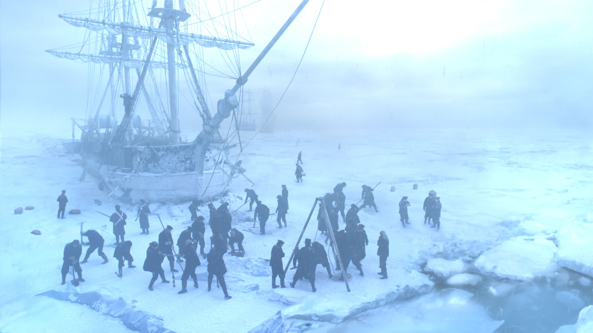The Royal Navy sailors fight with the thick ice to find a route through for ships Erebus and Terror. Credit: BBC/AMC Film Holdings LLC.