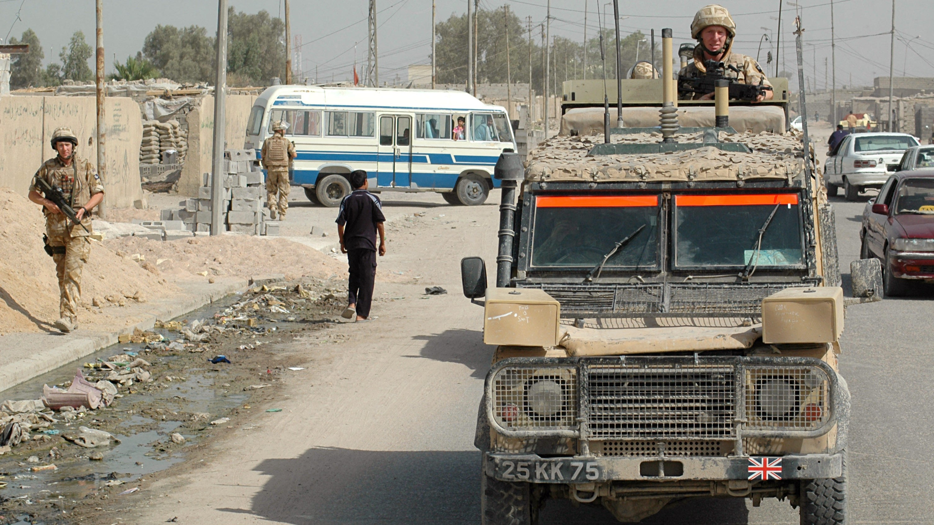 Soldiers of 1st Battalion Light Infantry patrol with an armoured Land Rover Snatch 2 in Basra, Iraq, in June 2006 (Picture: Alamy)