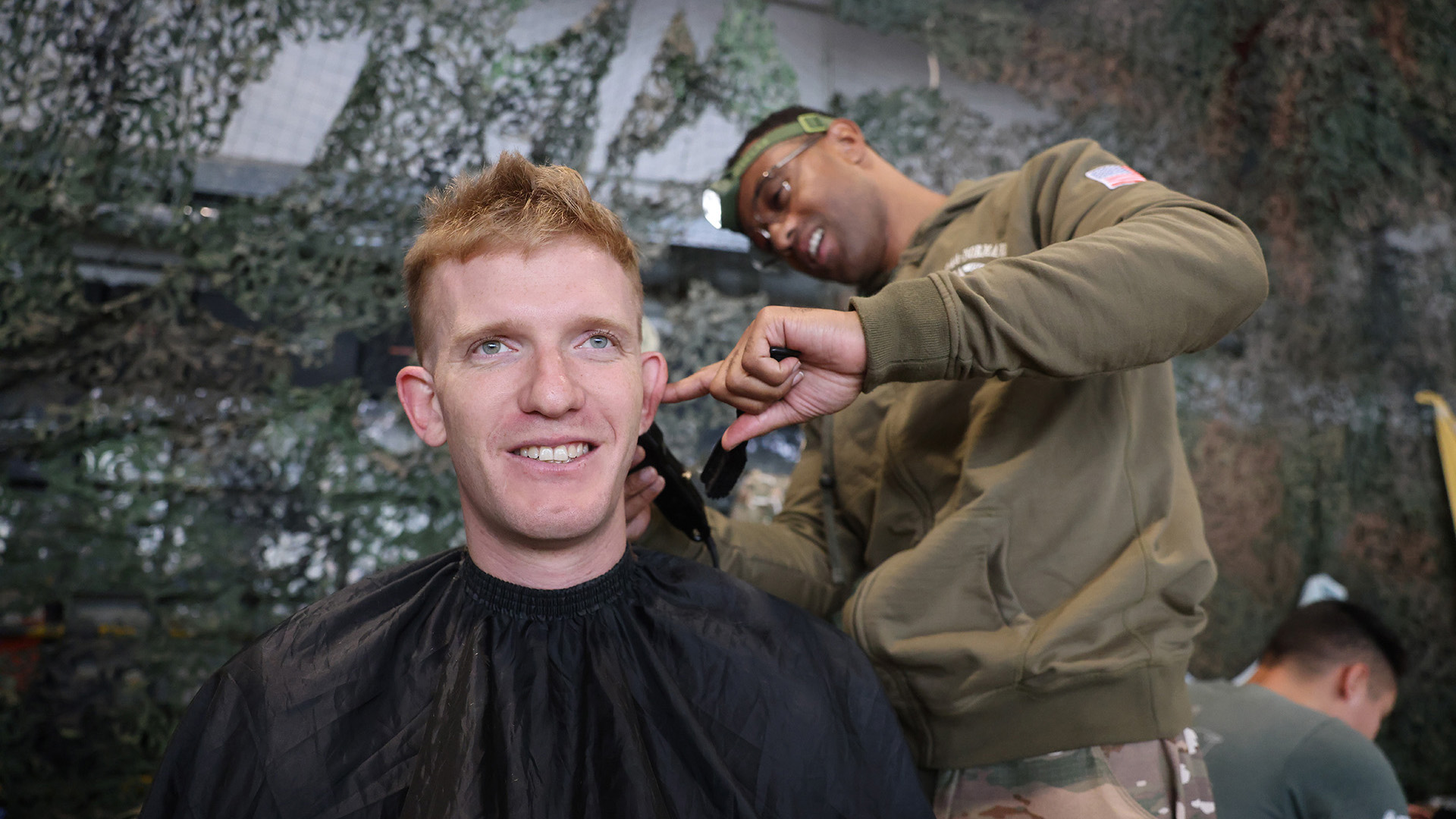 Part of exercise prep for some of the paras saw them get a pre-jump haircut (Picture: BFBS)
