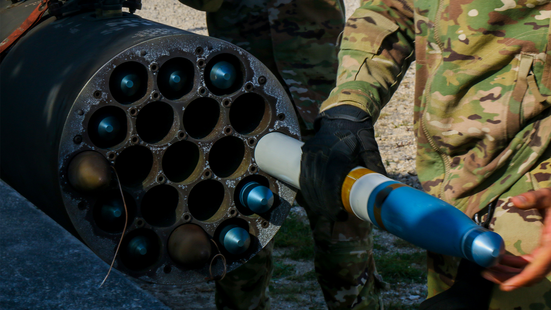 A US soldier loads a 70mm APKWS training round into a pod fitted to an AH-64 Apache - the system has been in use with the US military for more than a decade