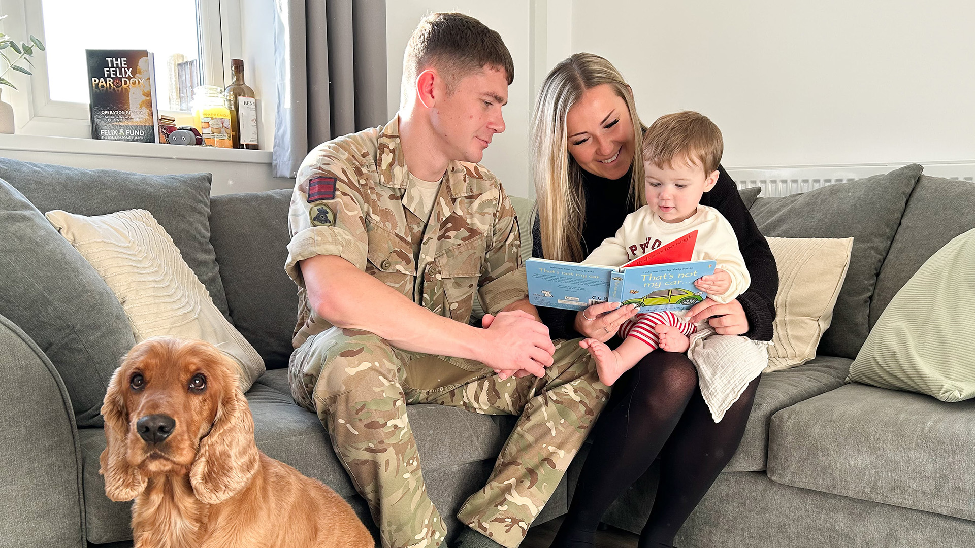 Cpl Crean, Nina, Charlie and hound in their renovated home 
