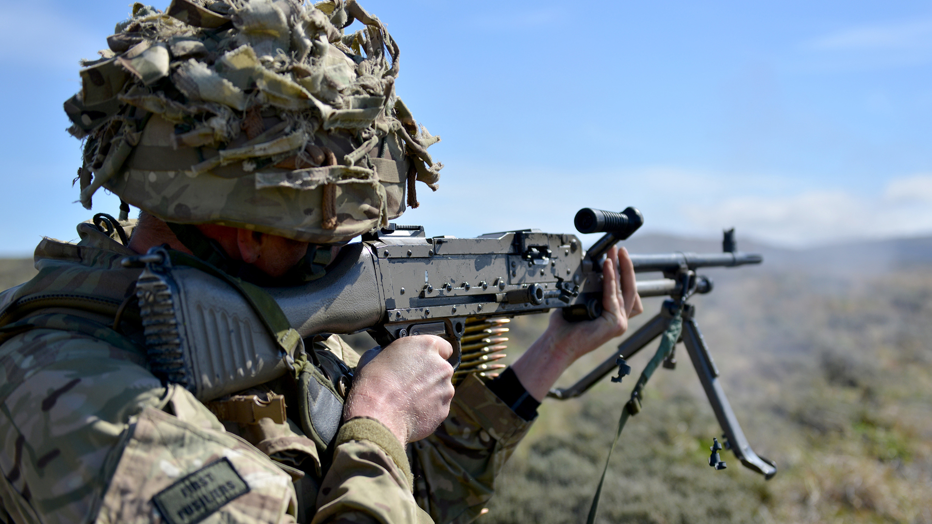 This infanteer from 1st Battalion the Royal Regiment of Fusiliers opens fire with his GPMG on a much sunnier day - note the disintegrating belt links being ejected along with the spent cases
