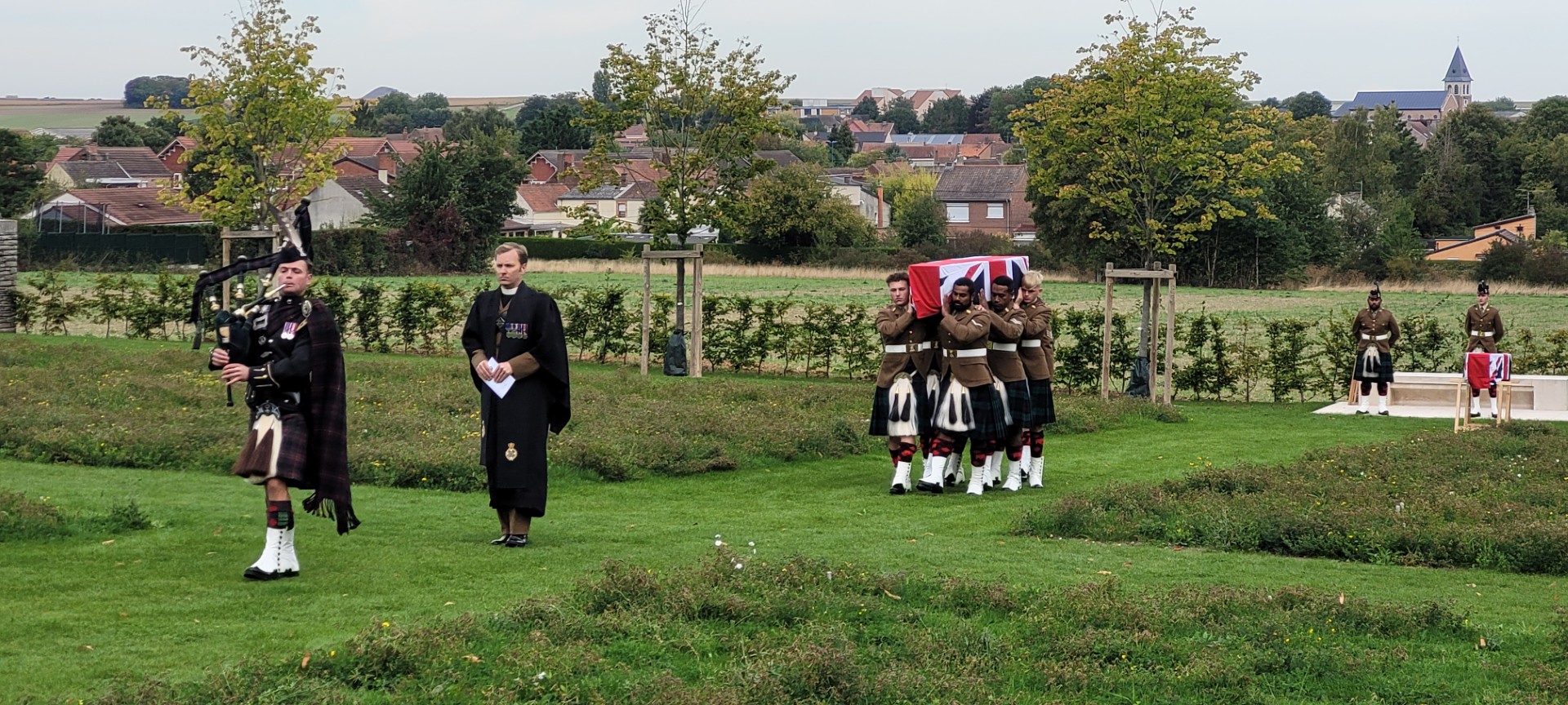 A Piper plays as the remains of Lt James Allan are carried to his final resting place by soldiers of the 4th Battalion The Royal Regiment of Scotland