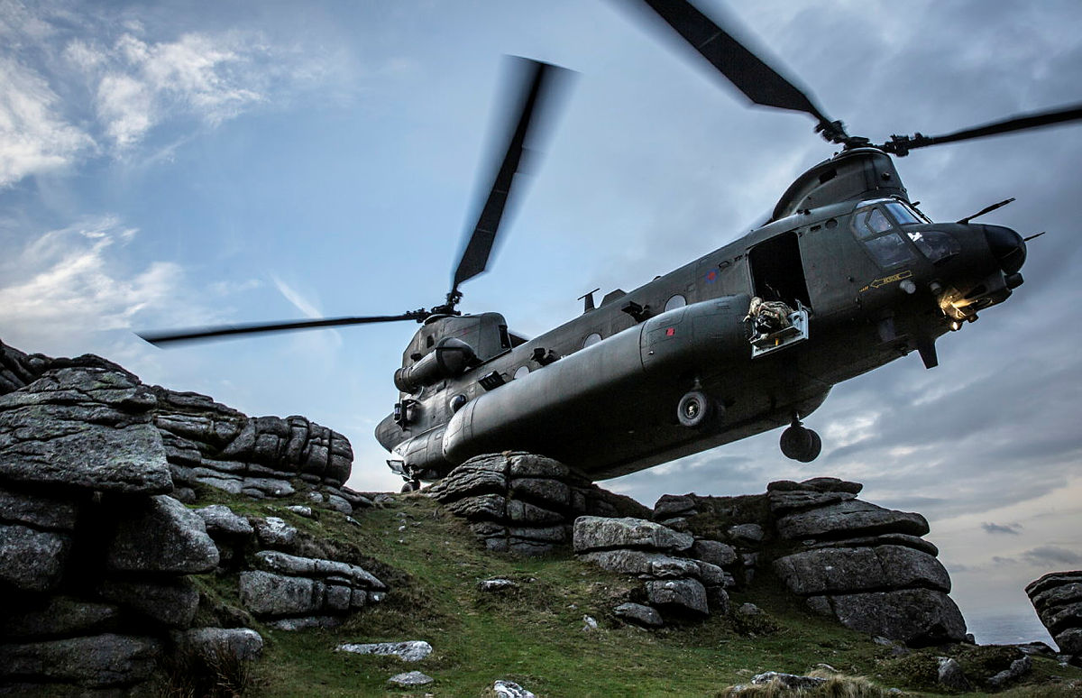 RAF Chinook helicopter hovering over a mountainside in Dartmoor