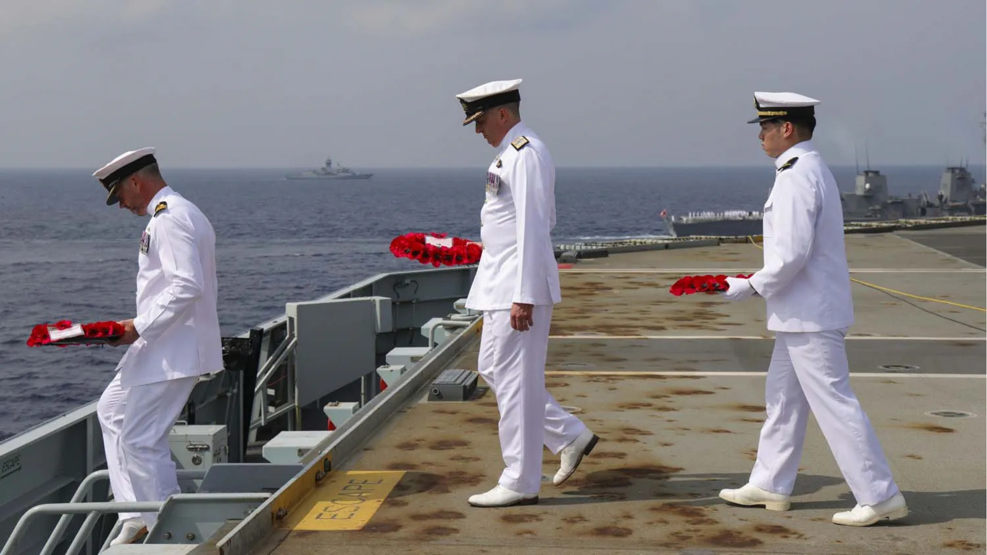 Committal Wreaths were laid by UK Commander Carrier Strike Group, Commodore James Blackmore, Commanding Officer of the aircraft carrier, Captain Will Blackett, and Sub Lieutenant Takumi Kitamura from the accompanying Japanese destroyer Akebono