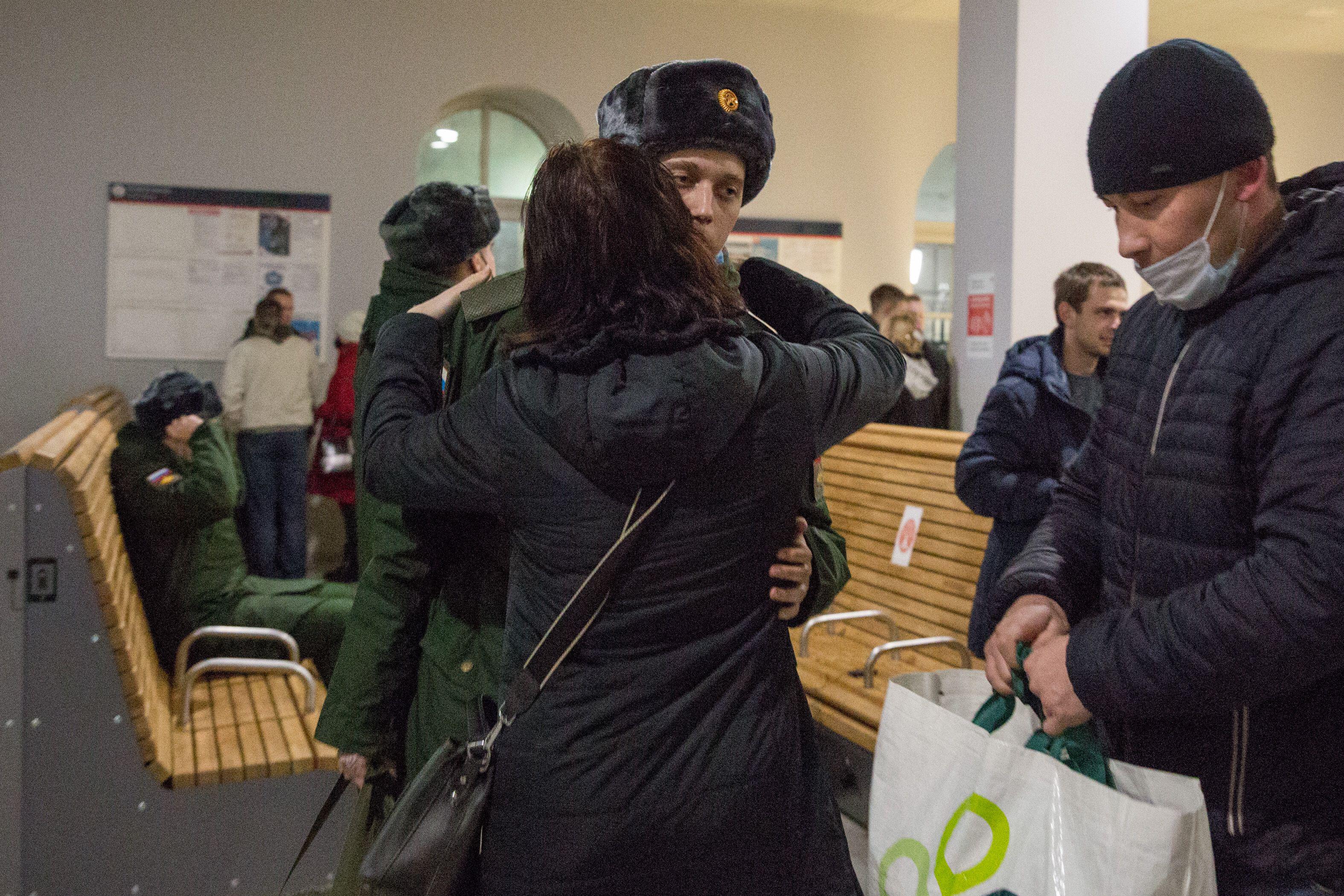 A new army conscript says goodbye before he sets off with a train to the military site in St. Petersburg