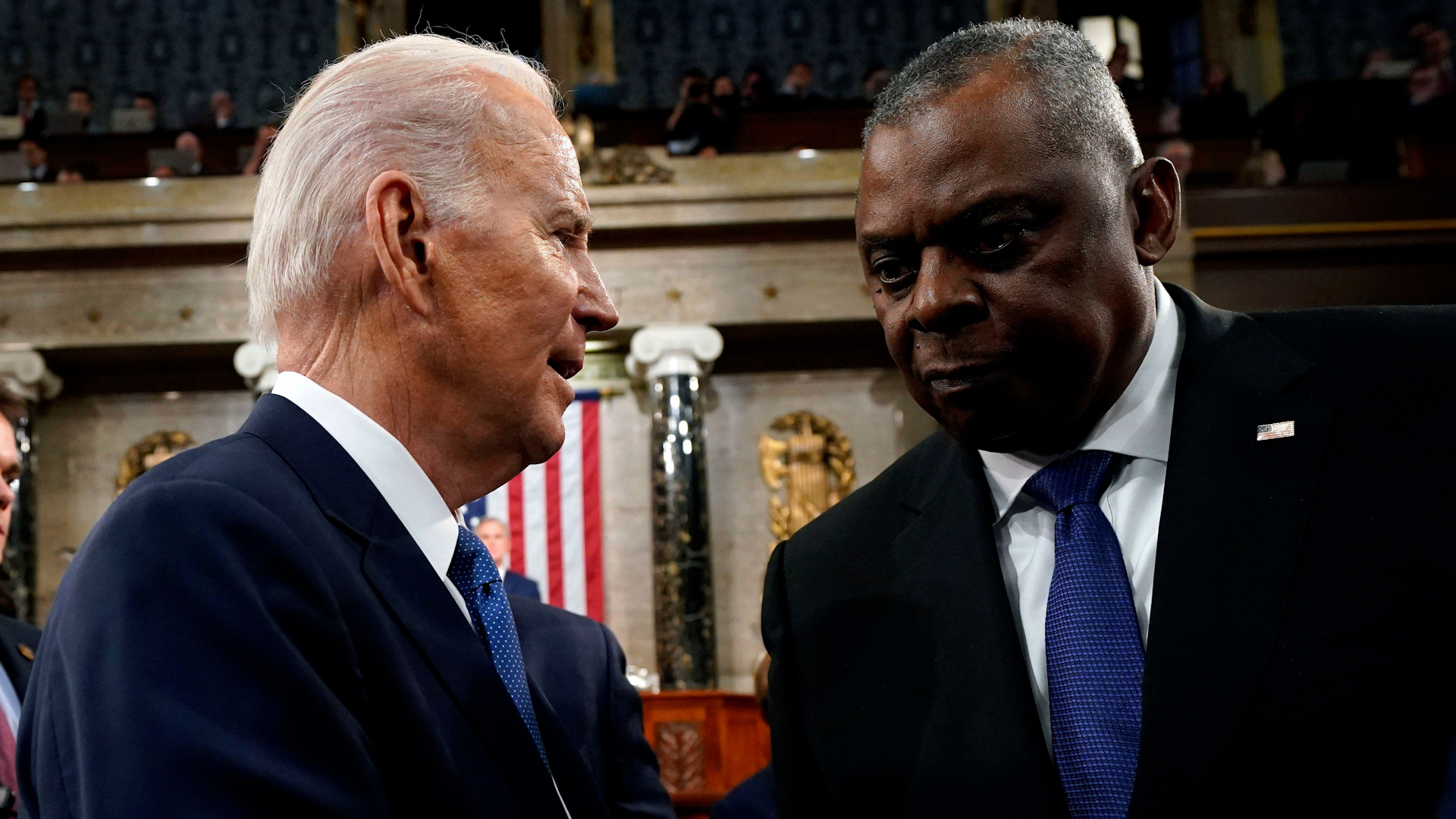 President Joe Biden talks with Defense Secretary Lloyd Austin after the State of the Union address to a joint session of Congress at the Capitol