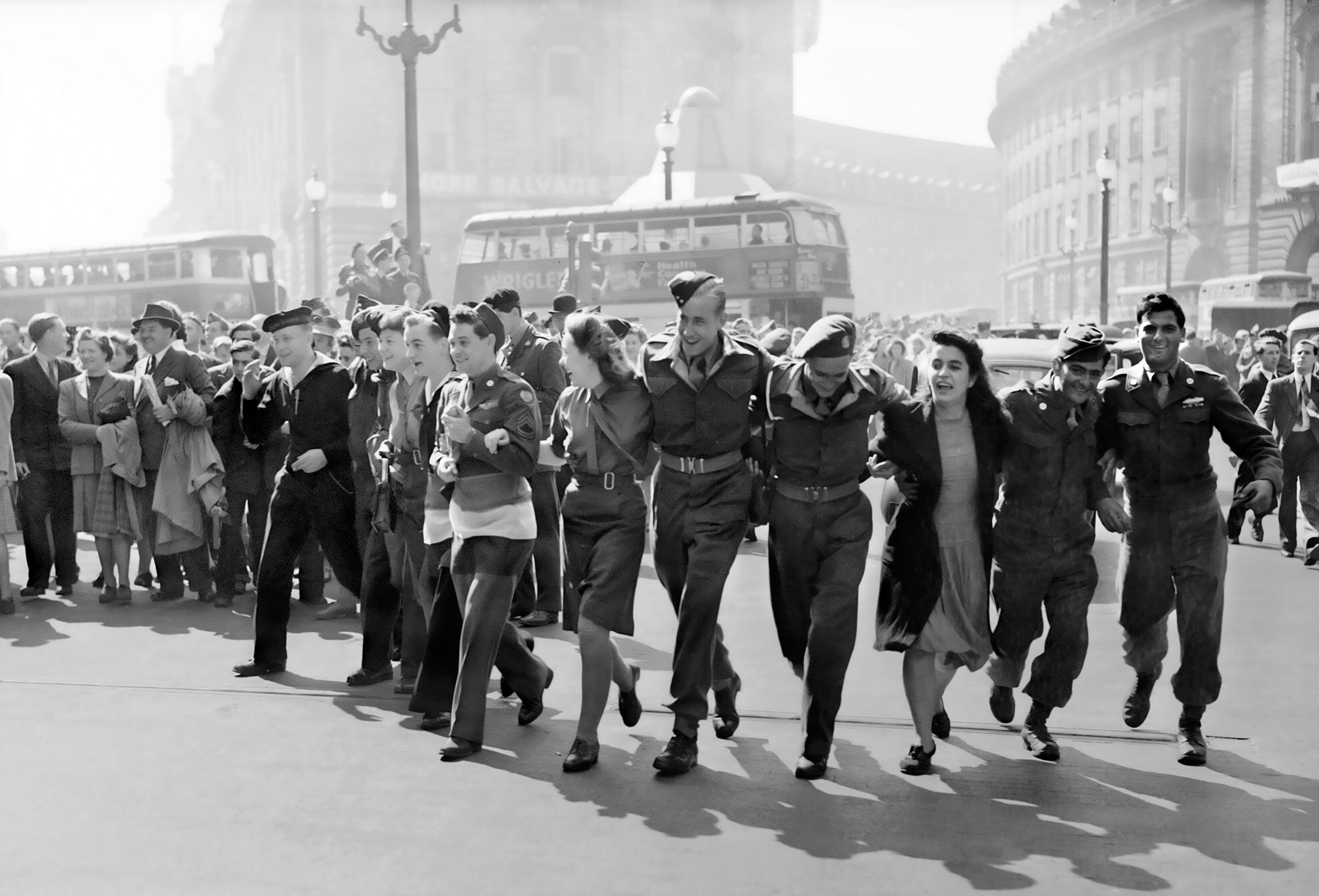 A crowd of people celebrating in Piccadilly Circus, London on VJ Day, 15 August 1945