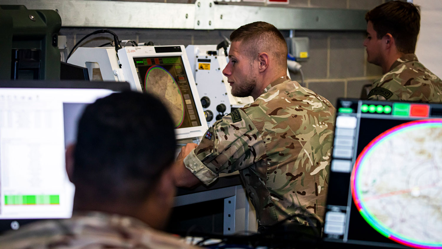 RAF Regiment personnel sat at screens, operating counter-uncrewed aerial systems equipment