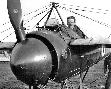 A pilot sitting in a French Morane-Saulnier N, with a deflector placed in front of the machine gun