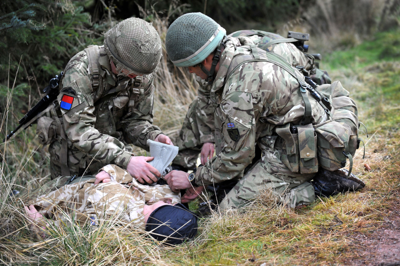 Soldiers treat simulated casualty. Credit: Sgt Rupert Frere, Crown Copyright
