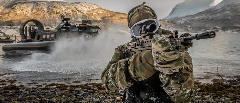 A Royal Marine from 539 Assault Squadron performing a beach assault from a Landing craft Air Cushioned (LCAC) Hovercraft  in Harstad, Norway.