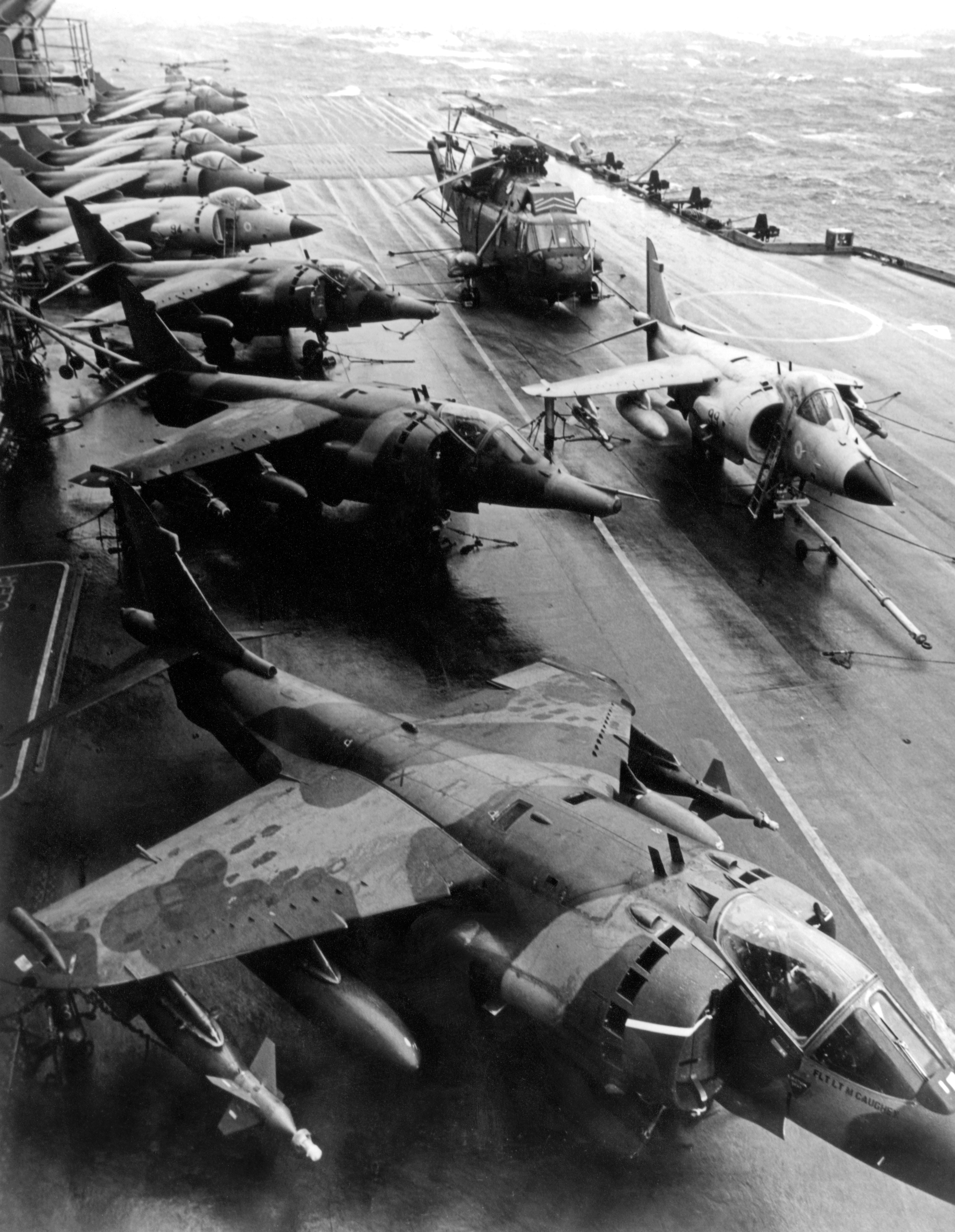 Harrier GR.3 aircraft of 1 Squadron parked alongside Royal Navy Sea Harriers and a Sea King helicopter on the flight deck of HMS Hermes on 19 May 1982, the day that 1 Squadron joined with Hermes in the South Atlantic. The Sea Harrier FRS.1 differed from the RAF's GR.3 in having extensive corrosion-proofing, a cockpit that was raised to provide the pilot with a better view, and a multi-mode radar called Blue Fox, which could search for targets in the air or on the sea.