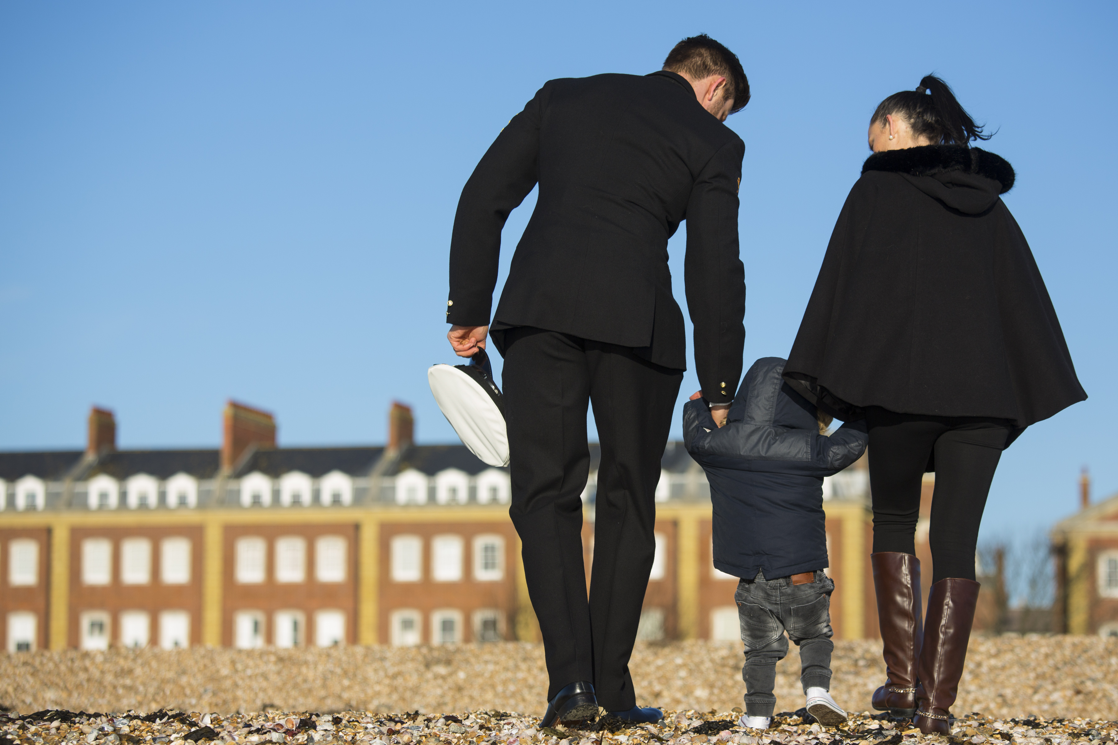 Royal Navy RNSPT and his wife and child walking on Portsmouth Beach.	UK MOD © Crown copyright 2019 
