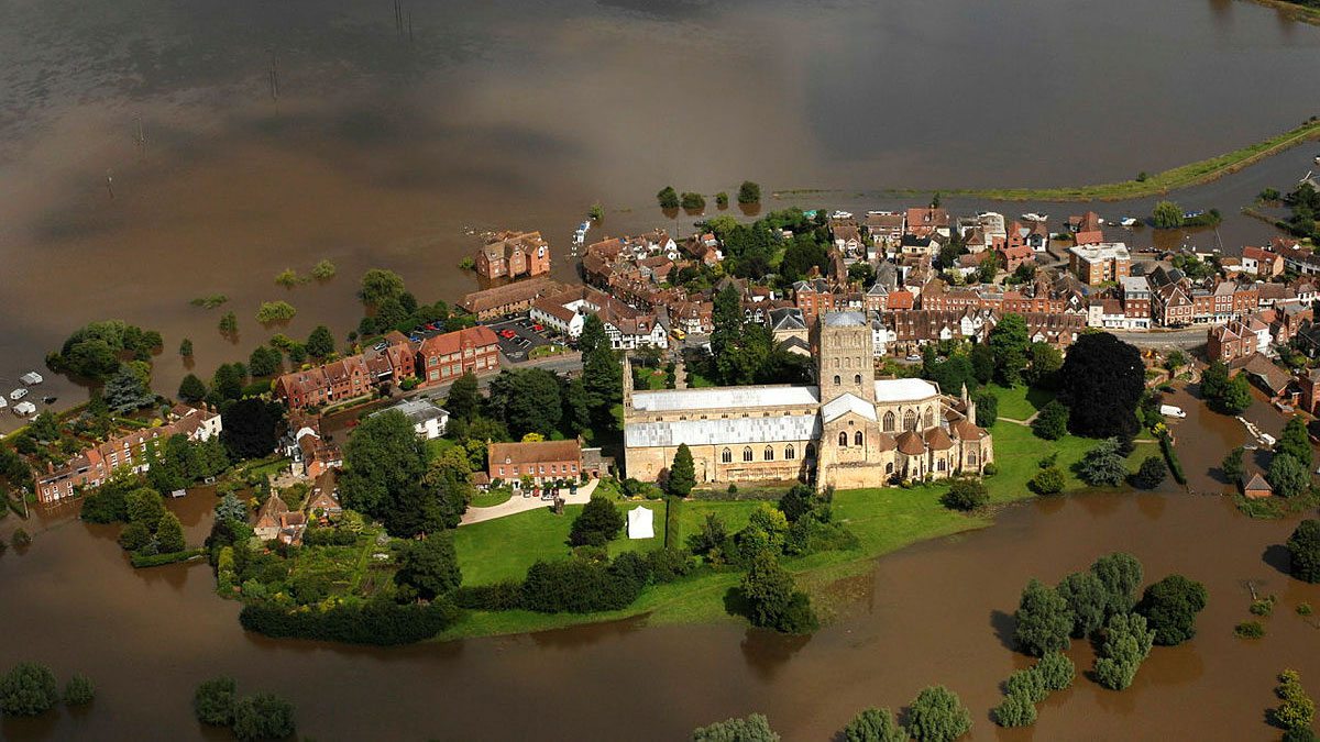 Tewkesbury Cathedral stands close to the water as the River Severn and the River Avon rise around it during the 2007 floods. (Picture: Crown Copyright / Stuart Bingham).