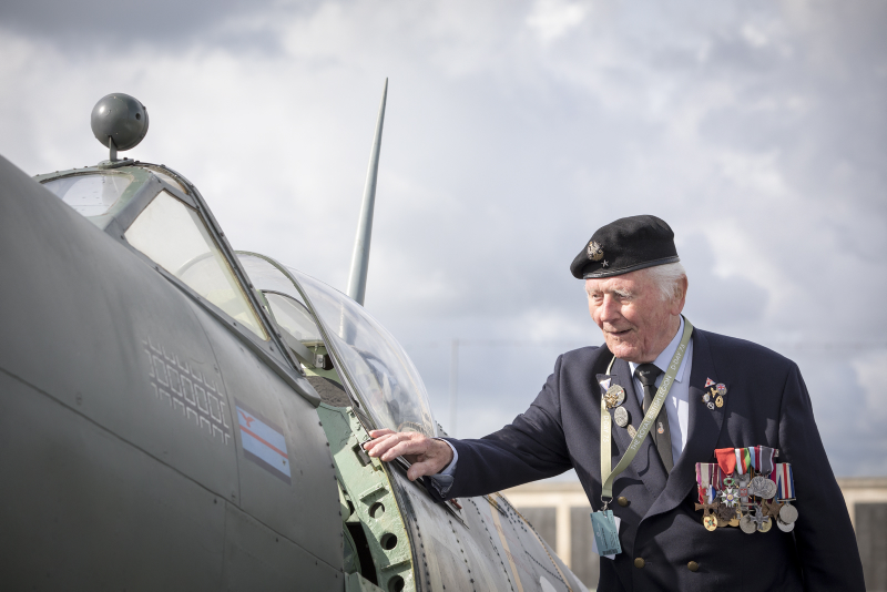 a veteran looking at a replica RAF Spitfire at the D-Day 75 National Commemorative Event in Portsmouth.