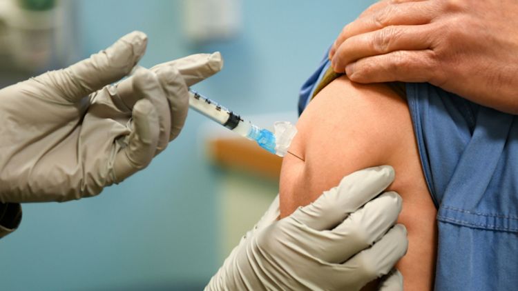 A COVID-19 vaccine is administered to US healthcare workers at Royal Air Force Lakenheath (Picture: US Department of Defense).