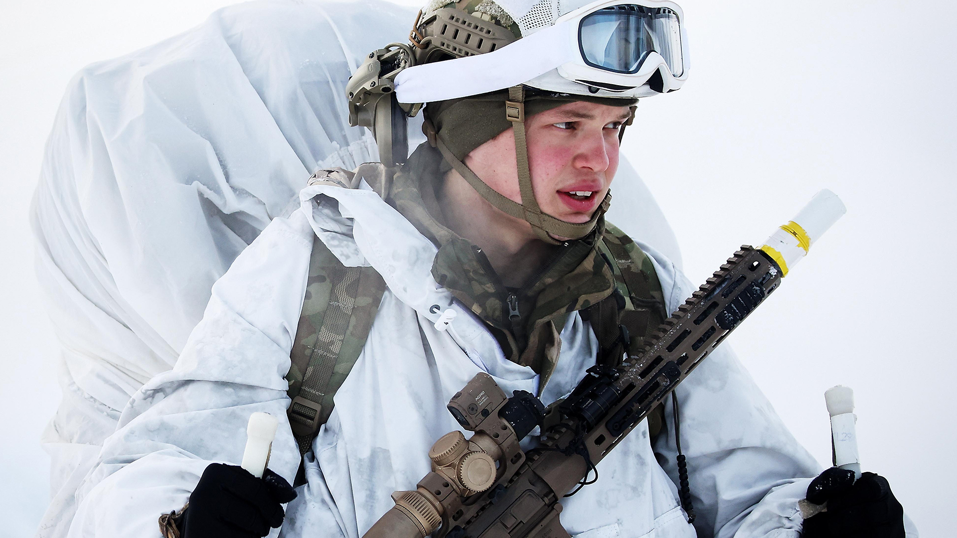 A Commando carries his L403 A1 assault rifle and bergen during cold weather training in Norway.