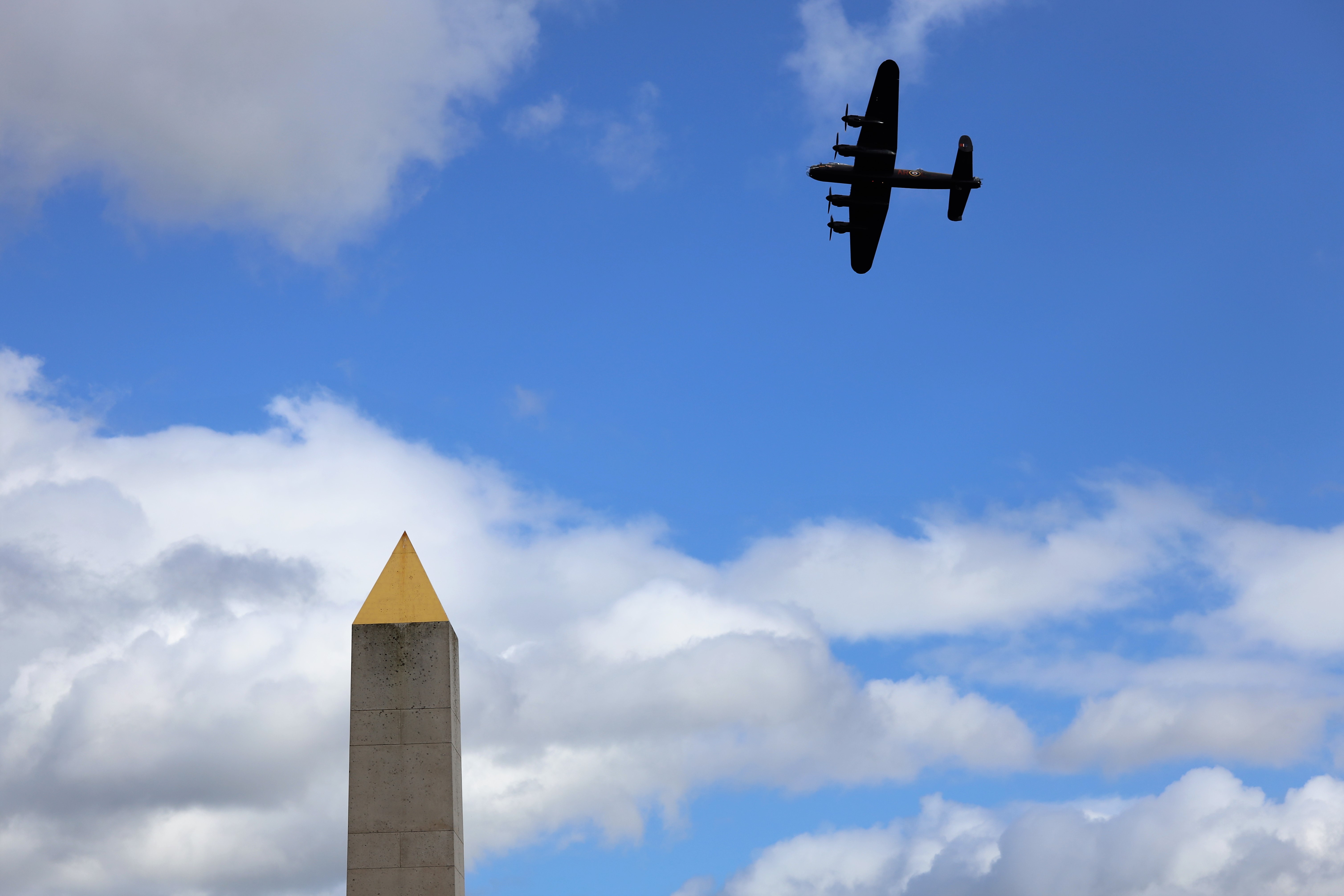 A Lancaster aircraft flies overhead the National Memorial Arboretum in Staffordshire during a Ride to the Wall event (Picture: National Memorial Arboretum).