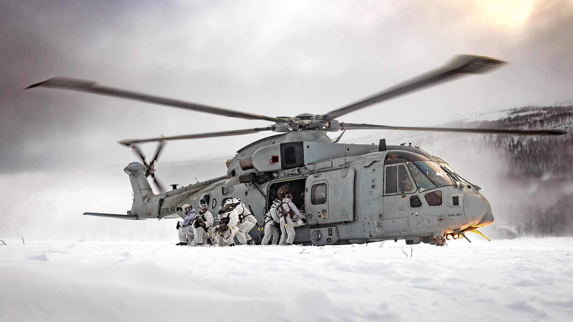 A Merlin Mk4 from 845 NAS disembarks troops from 45 Commando during a troop insertion exercise in Norway