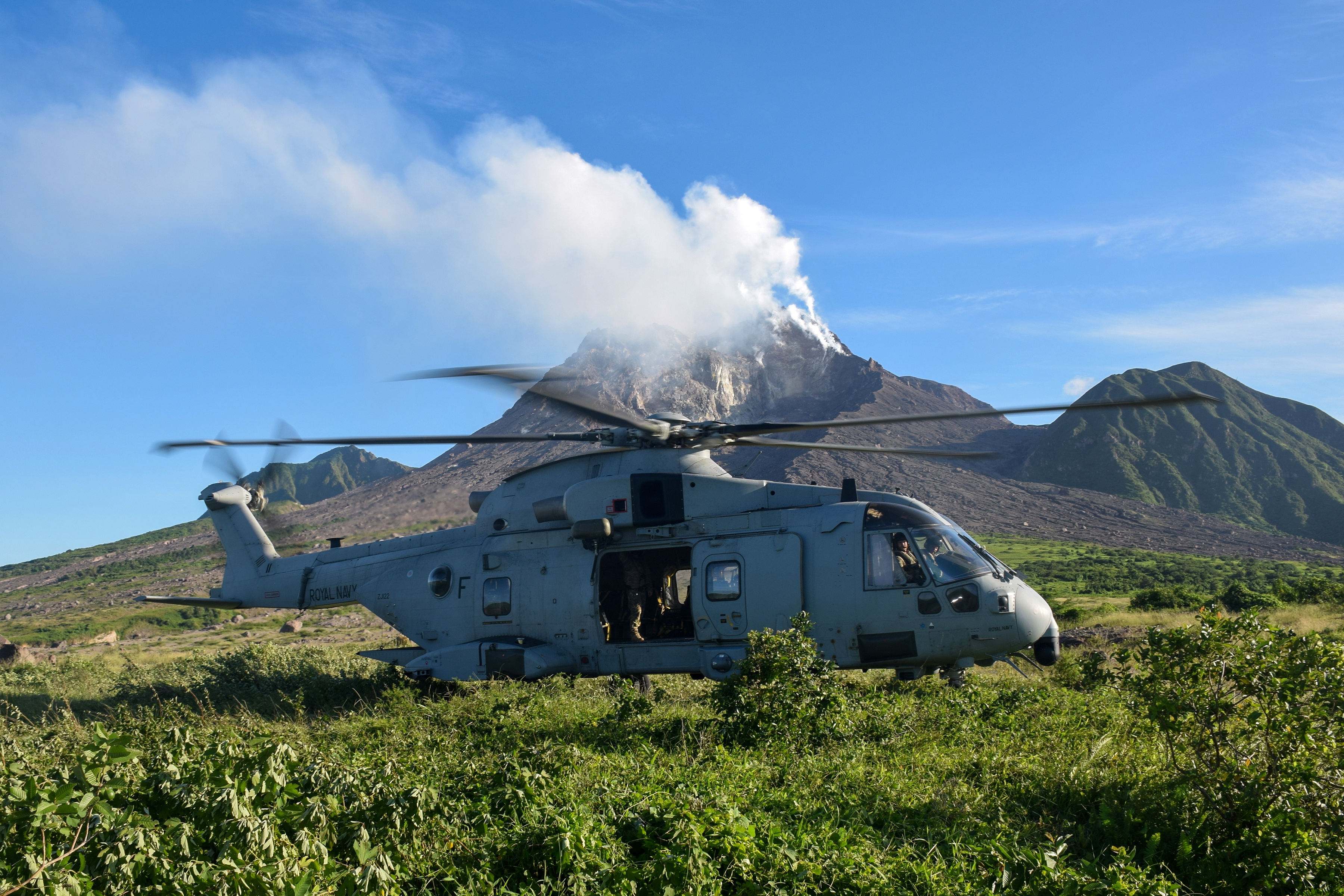 A Merlin Mk4 of 845 NAS lands in Monstserrat's exclusion zone with the smoking Soufrière Hills volcano in the background 271020 CREDIT ROYAL NAVY.jpg