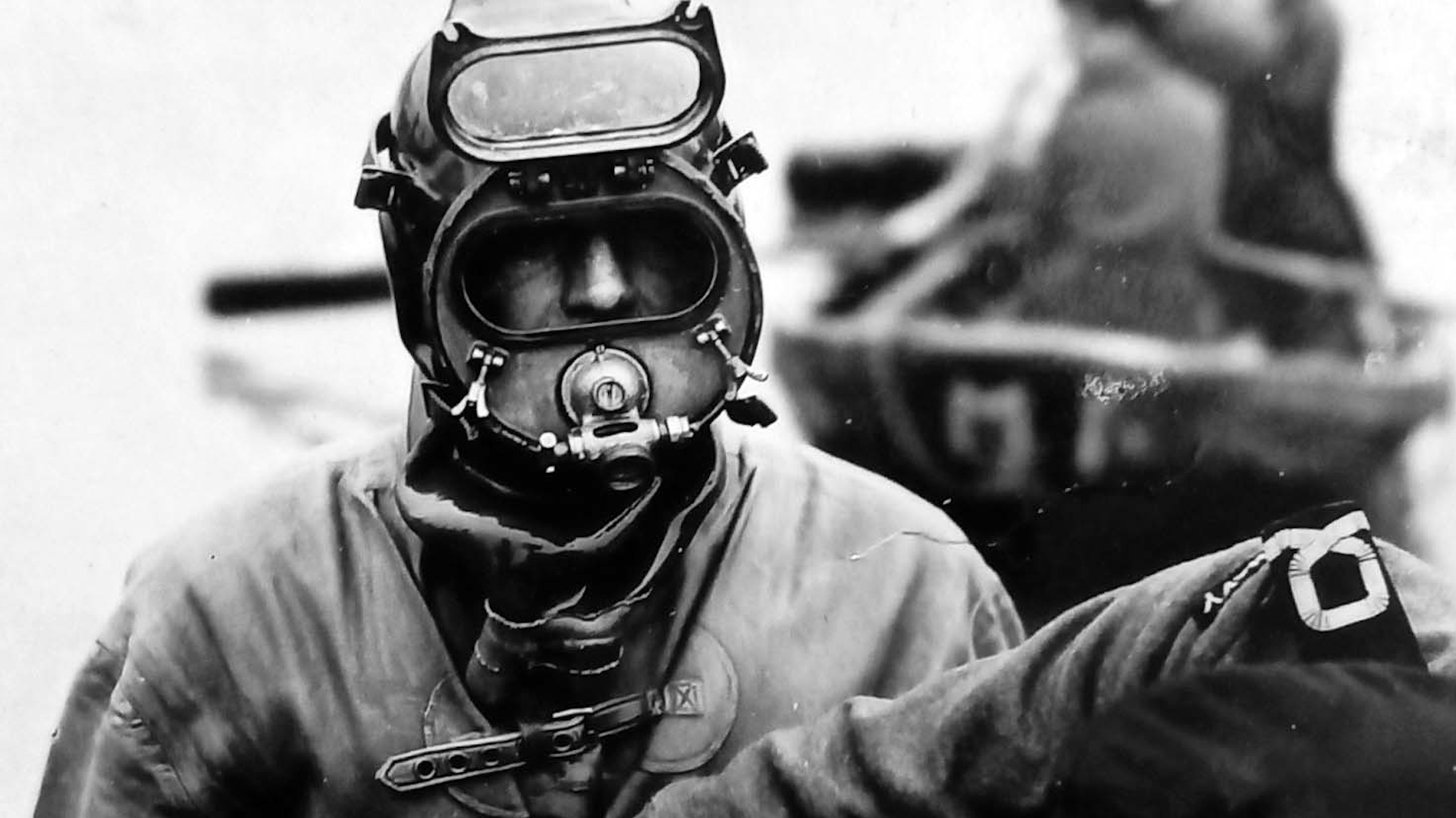 A P Party diver wearing his kit is readied for a dive during the Second World War. John would have operated in suits like this (Picture: Royal Navy).