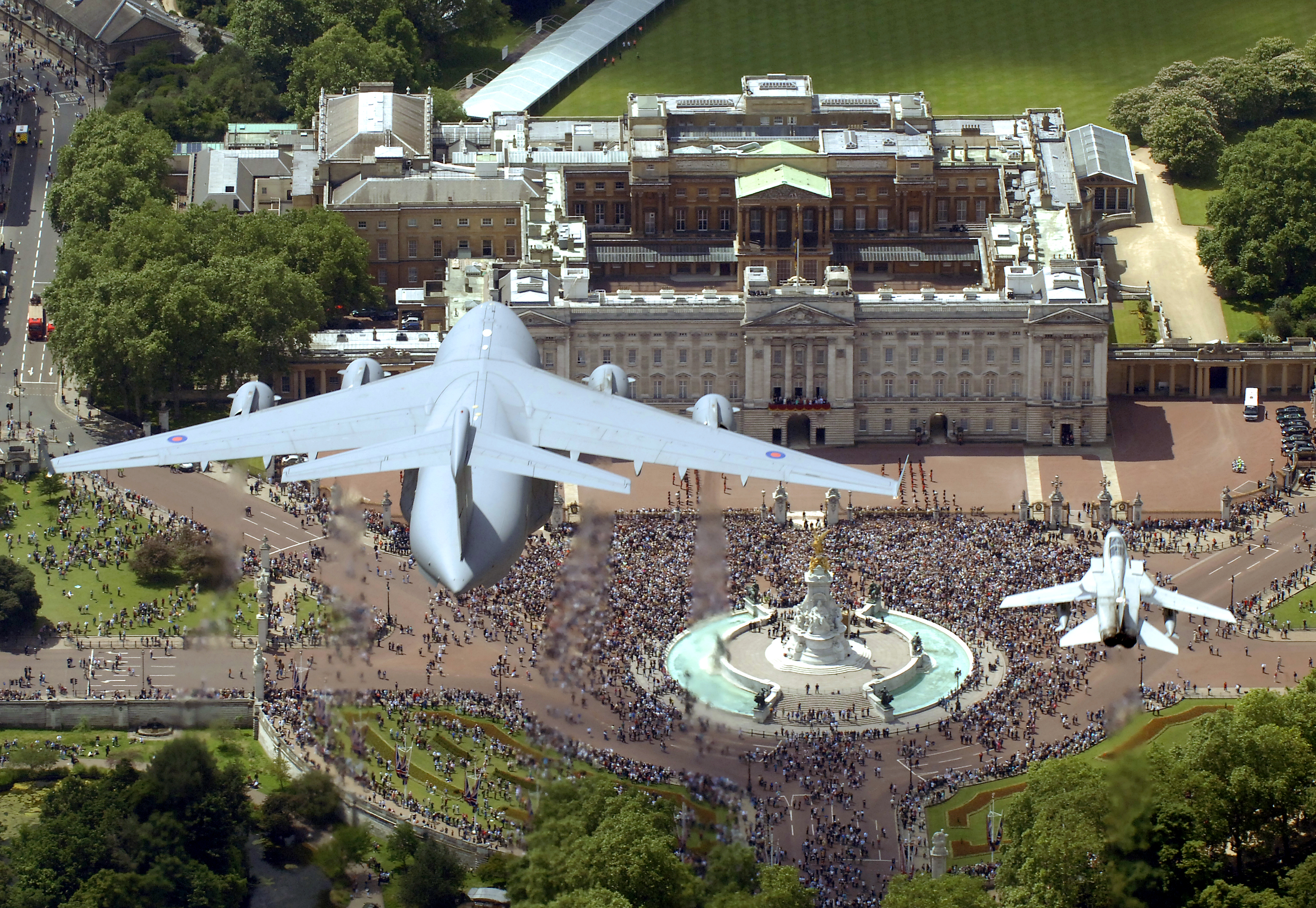 A RAF Tornado aircraft (right) escorts a giant C17 Globemaster above Buckingham Palace for Queen's birthday 140608 CREDIT MOD