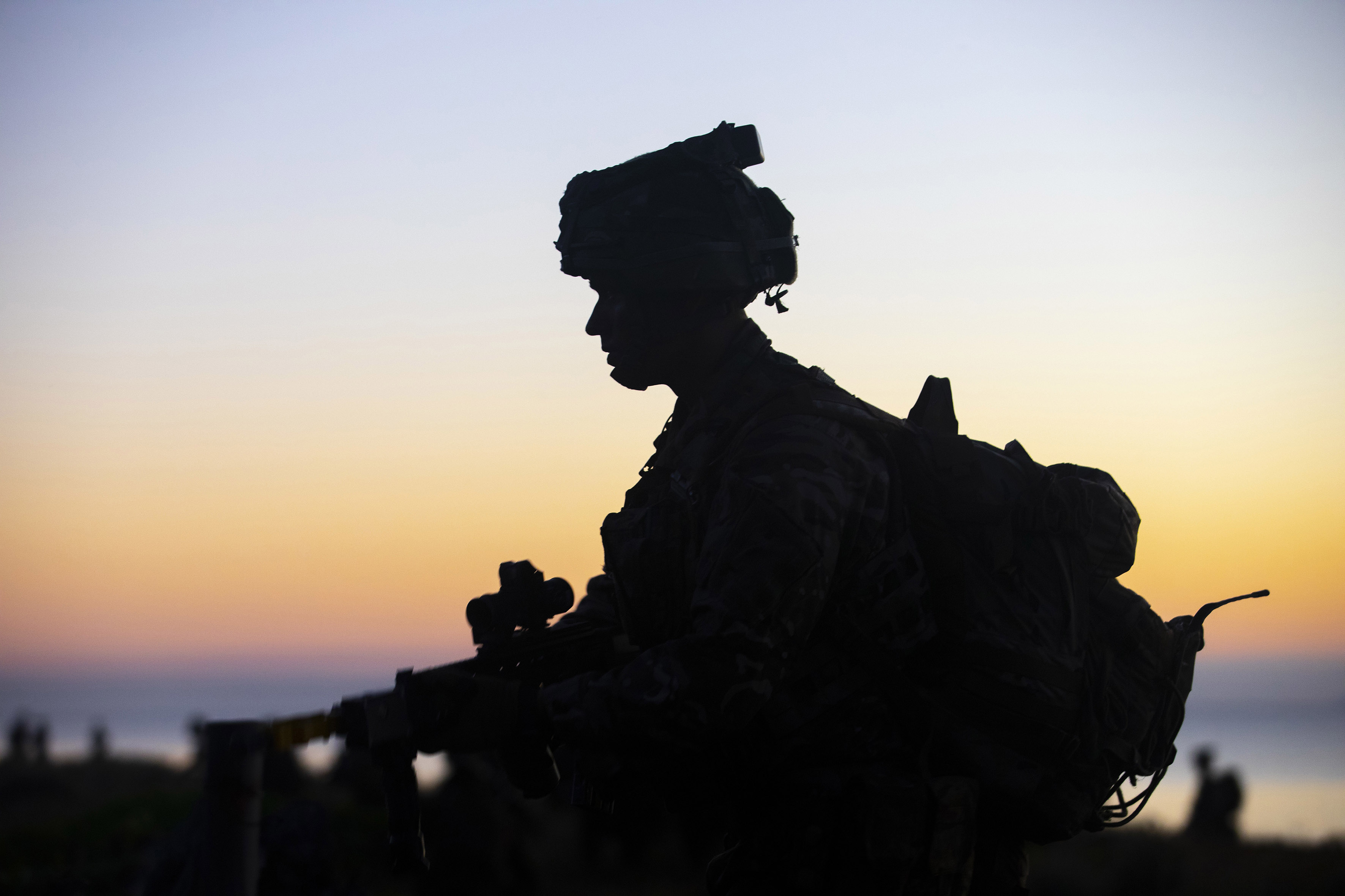 A Royal Marine of 40 Commando is silhouetted against the rising sun whilst participating in Australia's biggest military exercise