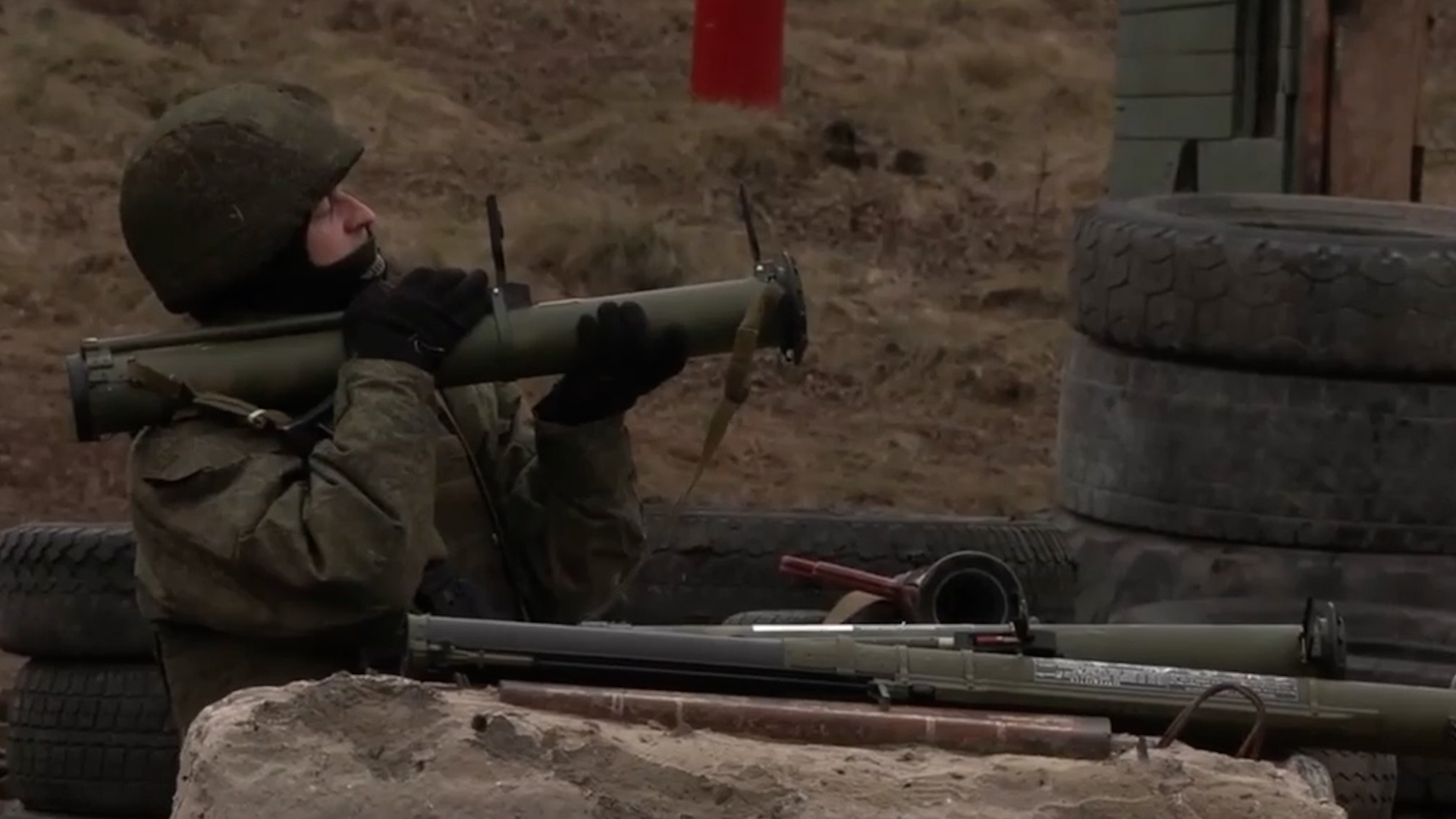 A Russian soldier looks up to fire his weapon