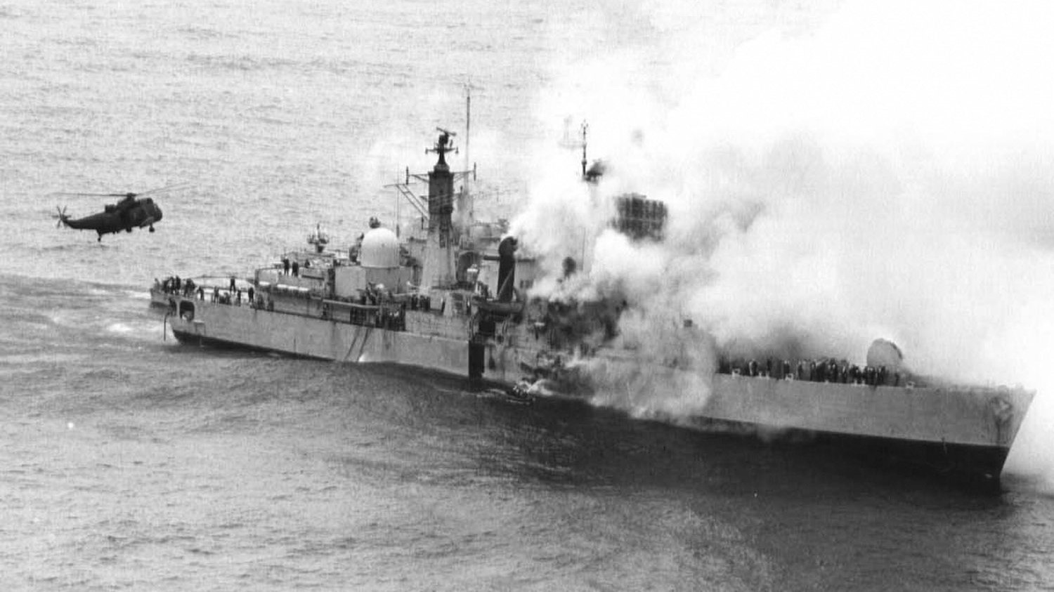 A Sea King hovers off HMS Sheffield's stern during rescue to recover ships company 04051982 CREDIT Navy MOD.jpg