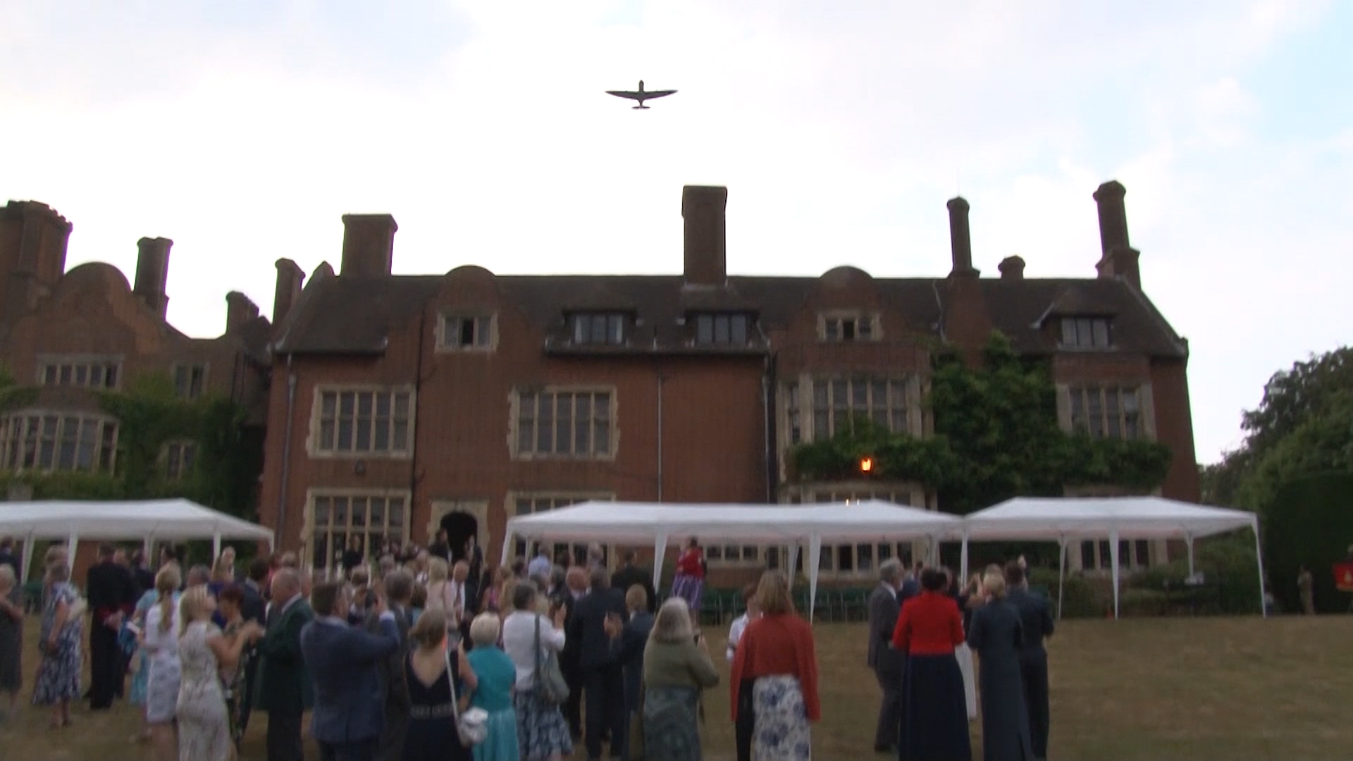 A Spitfire flies over Headley Court. 