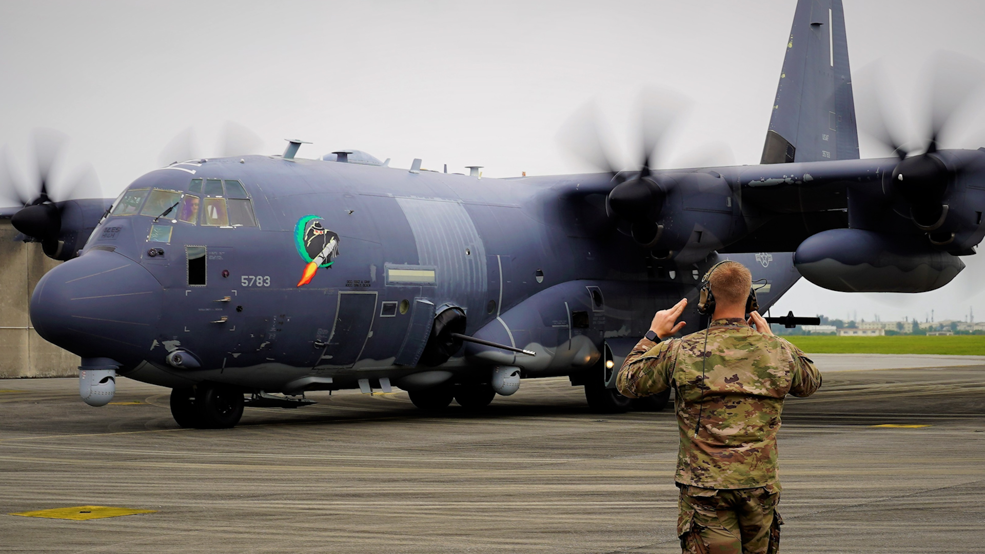 A US airman marshals an AC-130J Ghostrider to its parking location after landing at Kadena Air Base 29032021 CREDIT US Dept of Def