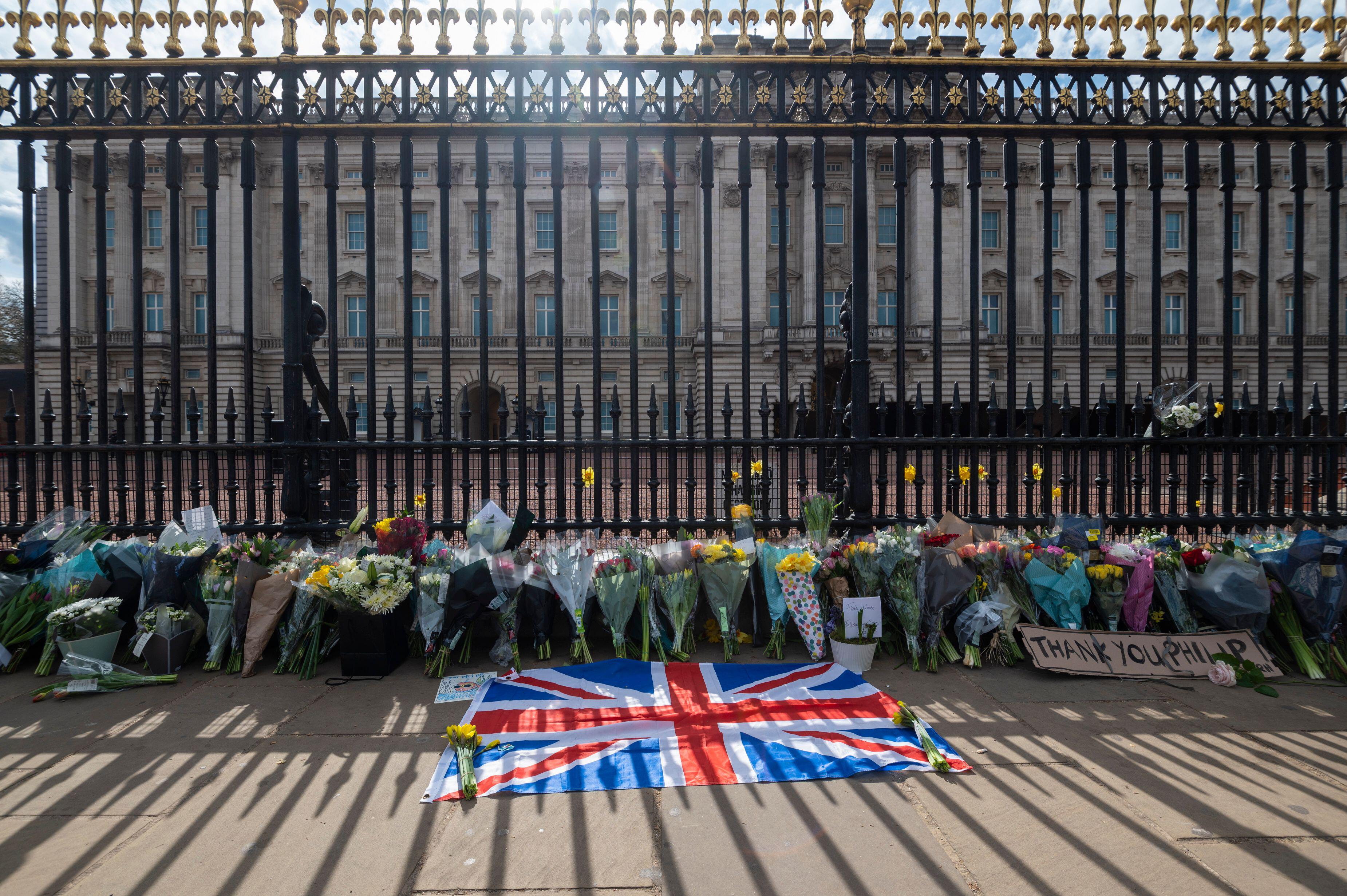A Union flag and flowers outside Buckingham Palace after the death of Prince Philip 090421 CREDIT ALAMY
