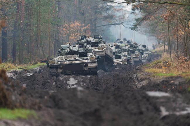 Legacy Warriors move through a forest in Poland during an exercise (Picture: MOD).
