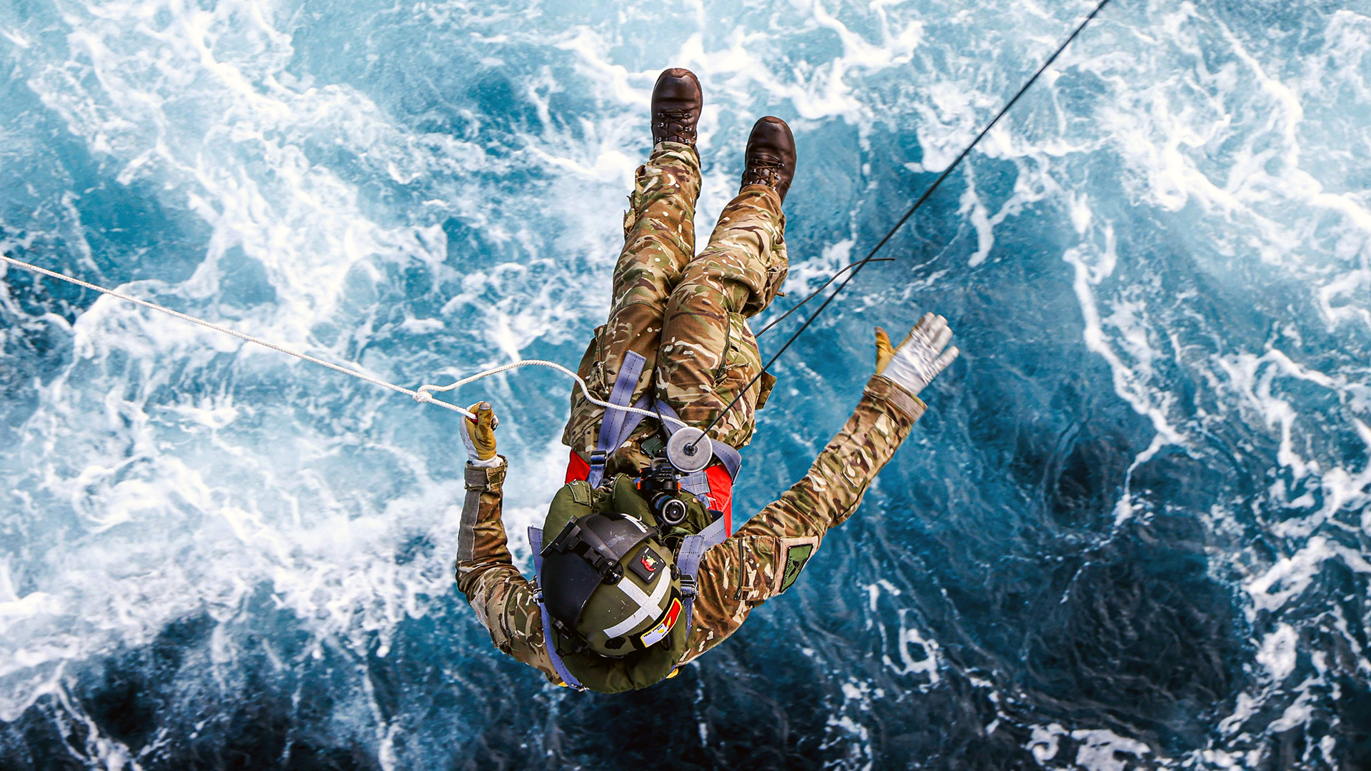 A crewman from 845 Squadron is carefully lowered from the Merlin Mk4