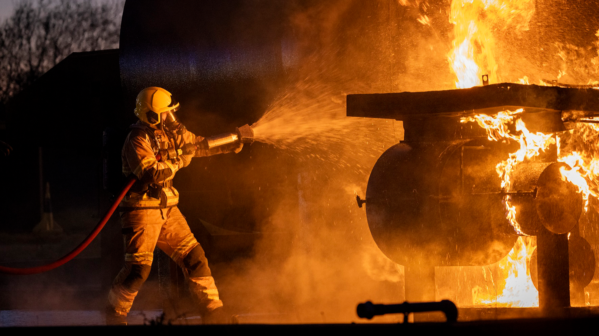 A firefighting engages the water cannon CREDIT RAF