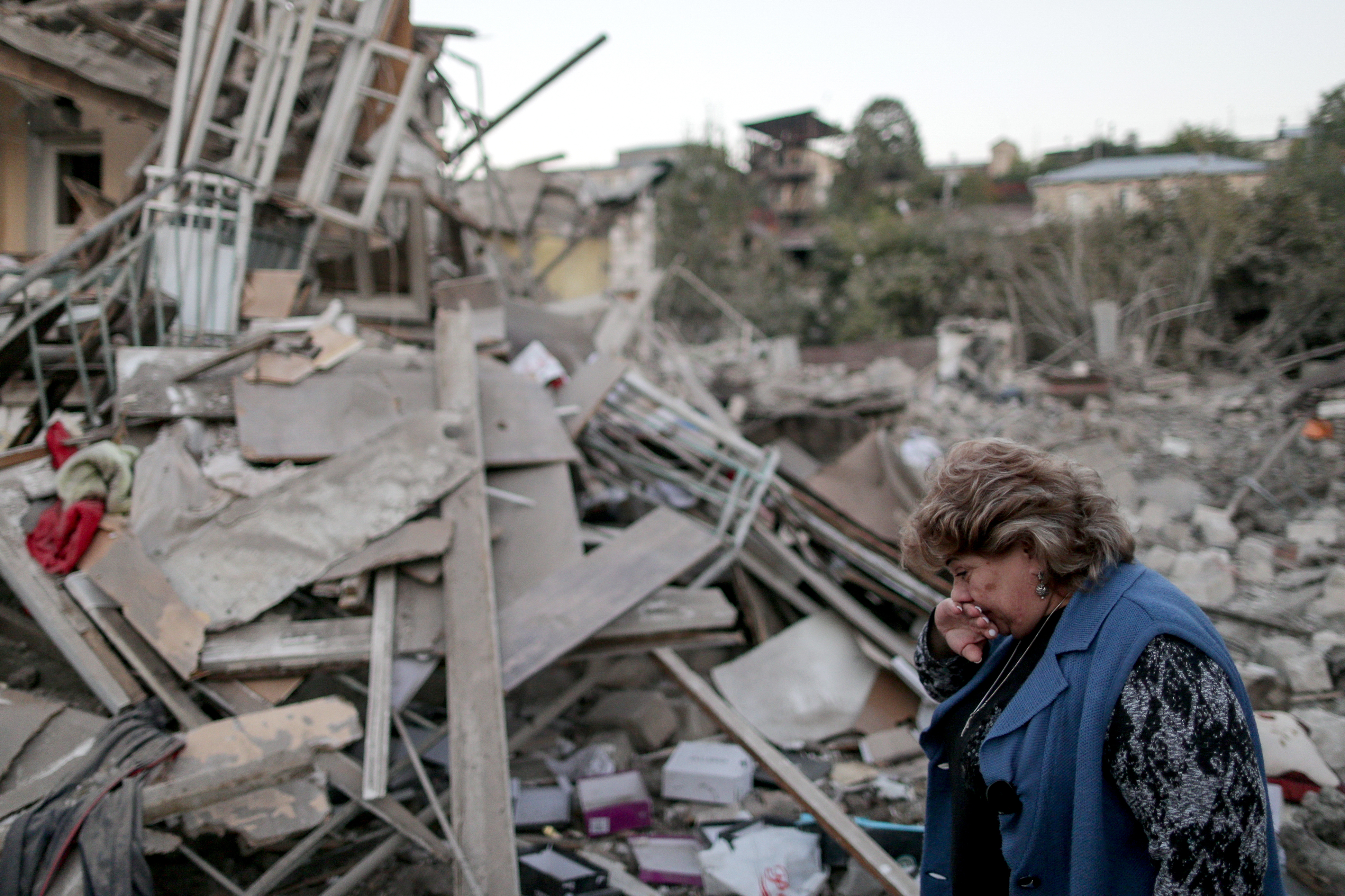 A local resident reacts by the ruins of a residential house destroyed in a night shelling attack in Stepanakert (Picture: PA).