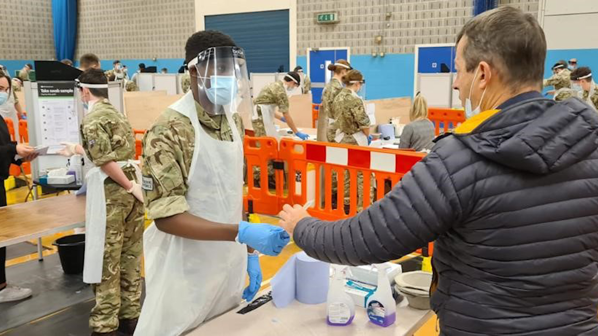 A member of the RAF provides assistance to the public as part of the first mass COVID testing scheme in Wales (Picture: MOD).