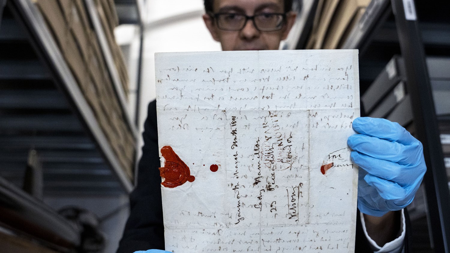 A museum curator holds one of Nelsons letter going on display 20102022 CREDIT Royal Navy.jpg