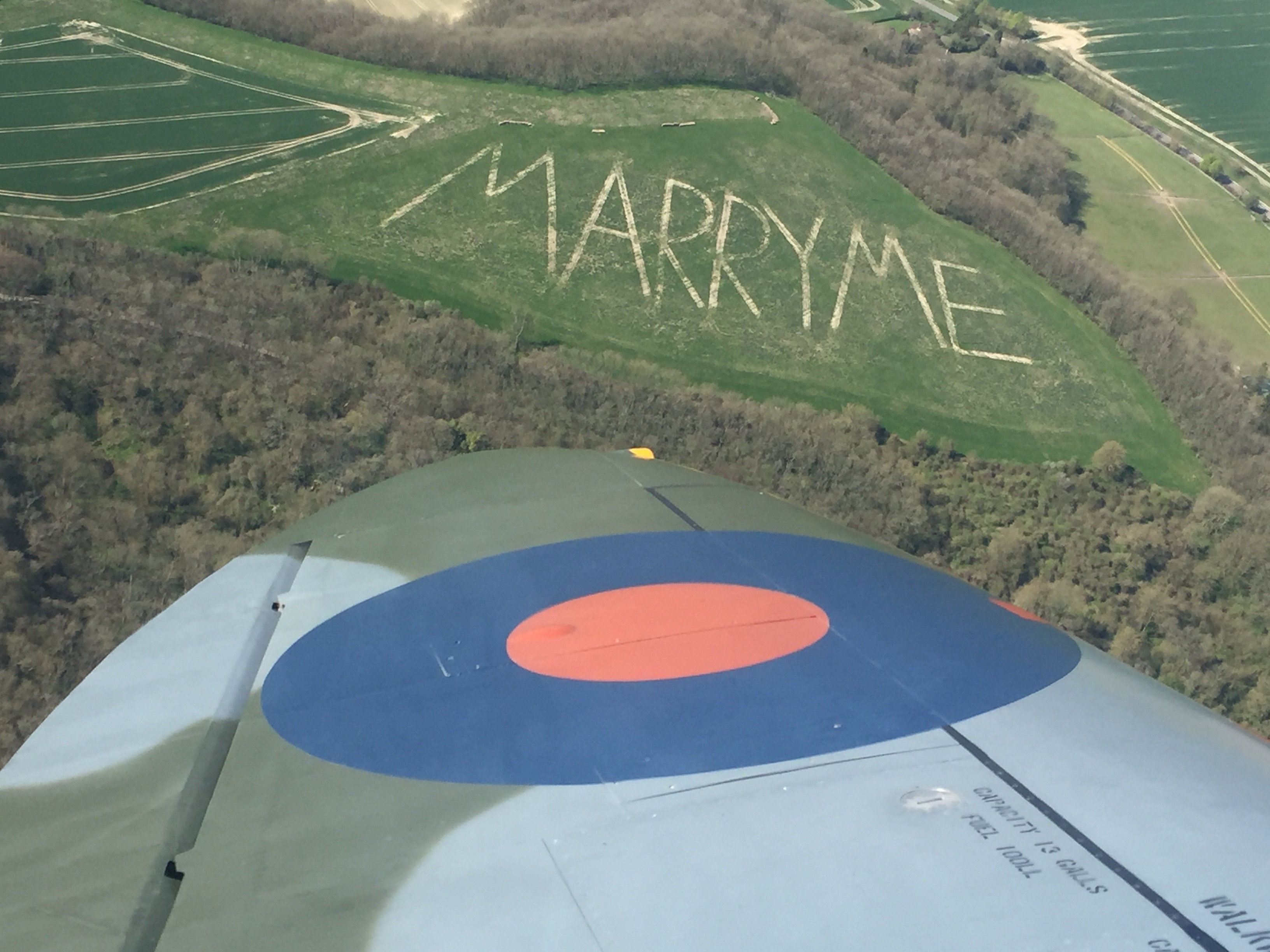 A pilot behind the controls of a WWII Spitfire was delighted when he discovered a giant marriage proposal - written in huge letters on a hill IMAGE BOULTBEE FLIGHT ACADEMY.jpg