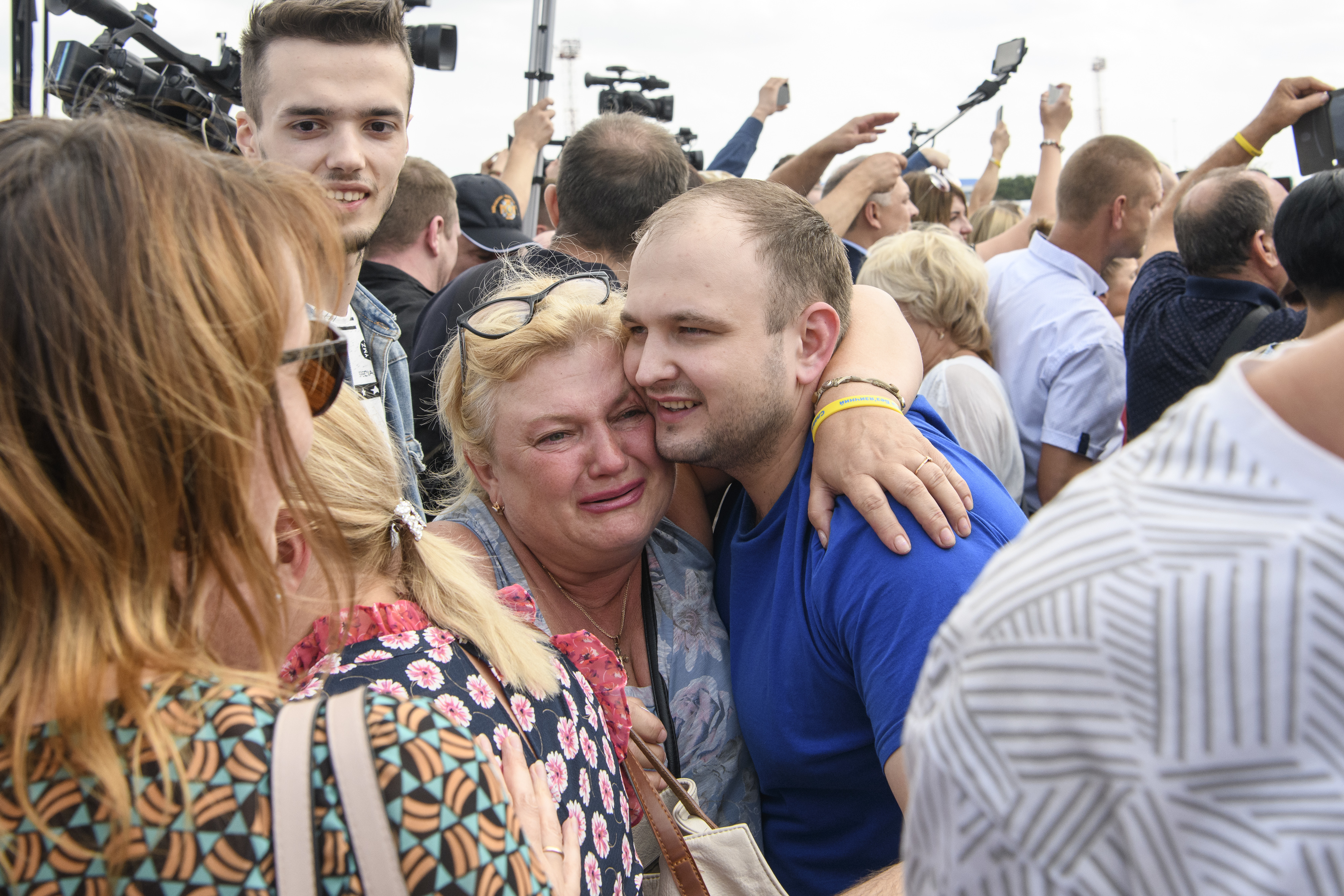 A Ukrainian prisoner is embraced as he arrives in Kyiv after a prisoner swap with Russia (Picture: PA).
