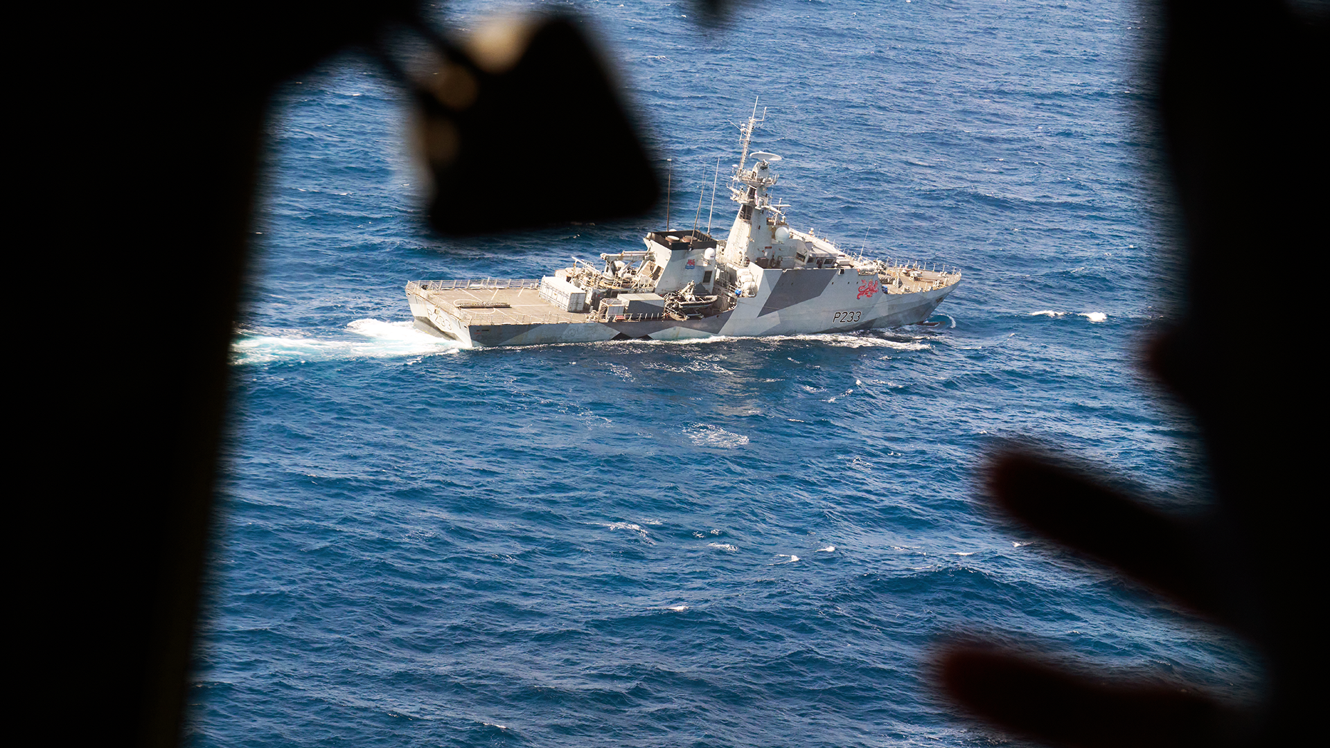 A wave from the cockpit of the C27J Spartan to HMS Tamar CREDIT ROYAL NAVY