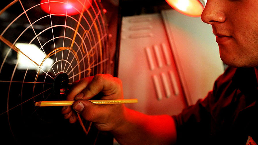 A Royal Navy Seamen Specialist marking a navigational plot on the bridge of Type 22 frigate HMS Cornwall CREDIT Crown Copyright