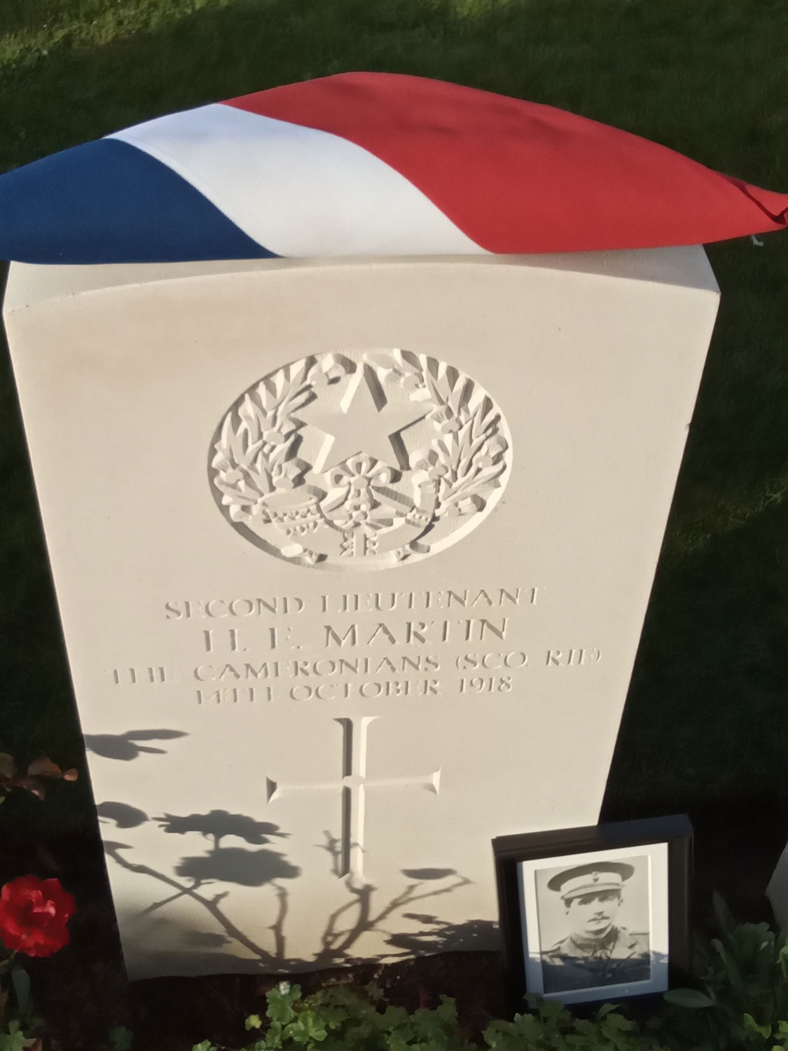 A photo of 2Lt Martin is placed by his new headstone CREDIT Crown Copyright