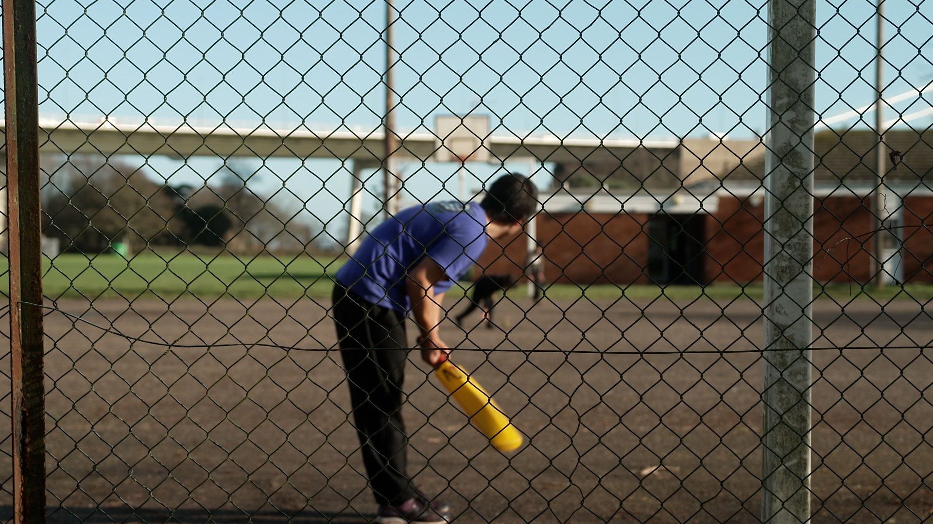 An Afghan child playing cricket at a UK military base after arriving via a resettlement scheme