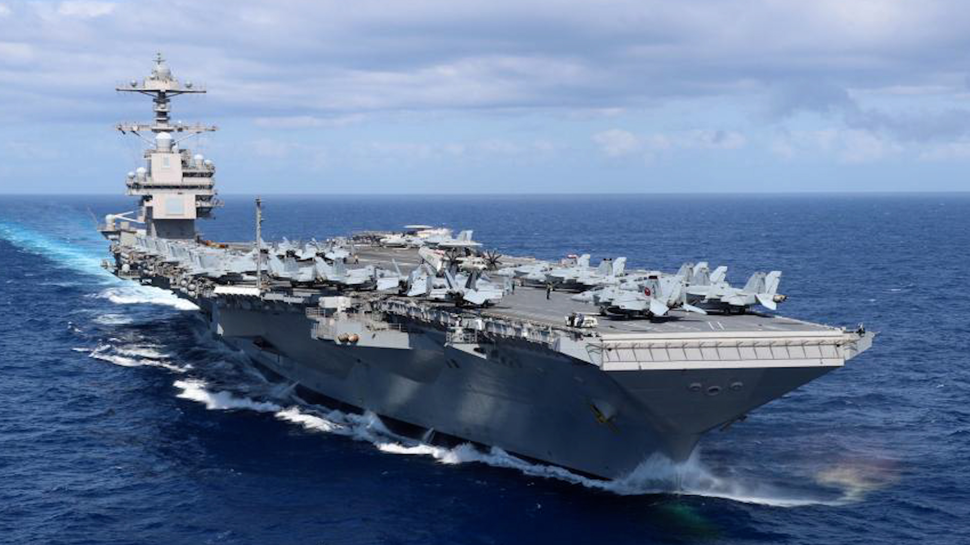 Aircraft sit on USS Gerald R. Ford's flight deck as the ship steams through the Atlantic Ocean prior to maiden deployment (Picture: US Department of Defense).