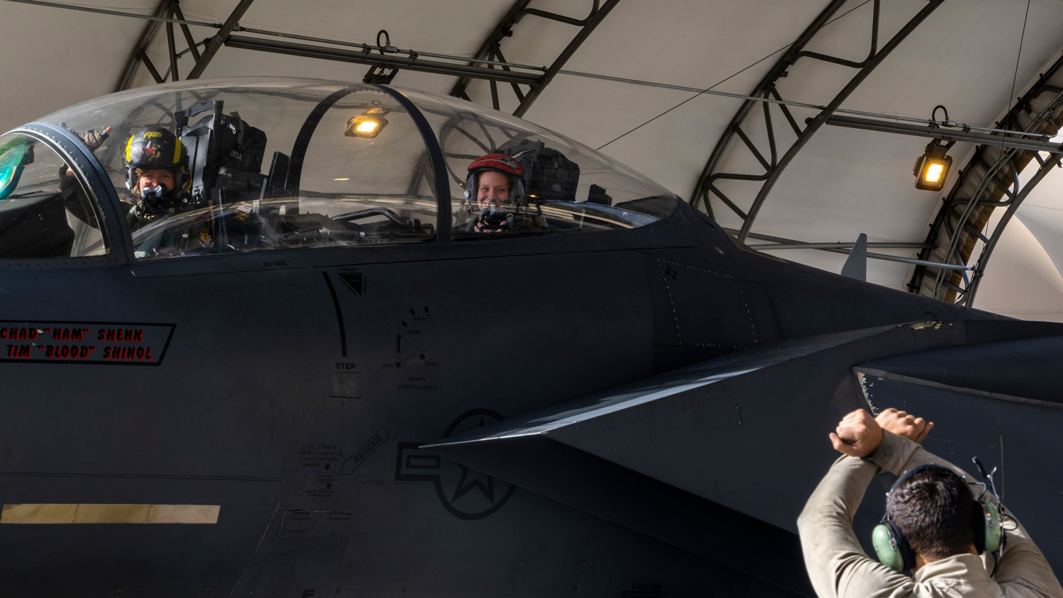 An Airman assigned to the 4th Fighter Wing marshals an F-15E Strike Eagle into a hangar after taking part in a fini-flight at Seymour Johnson Air Force Base, North Carolina in November 2022 Image ID 221114-F-XN600-1039 CREDIT US Air Force AND Senior Airman Kylie Barrow
