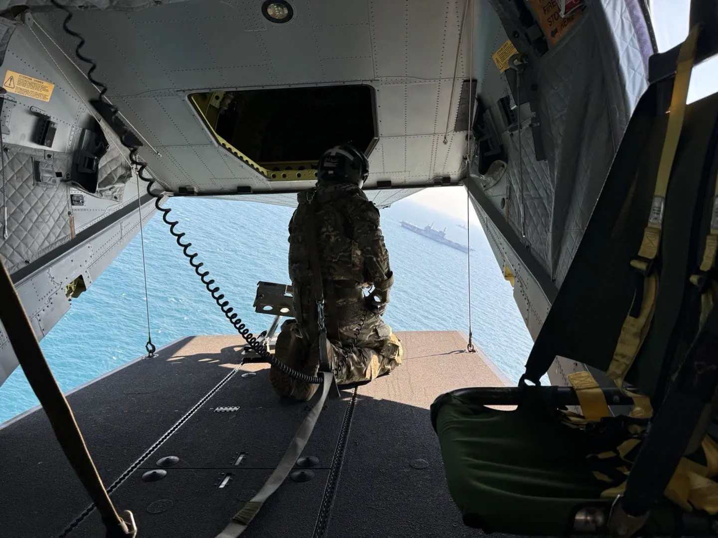 An Aircrewman enjoys the view from the loading ramp while deployed as part of the Royal Marine Commandos 281024 CREDIT Royal Navy