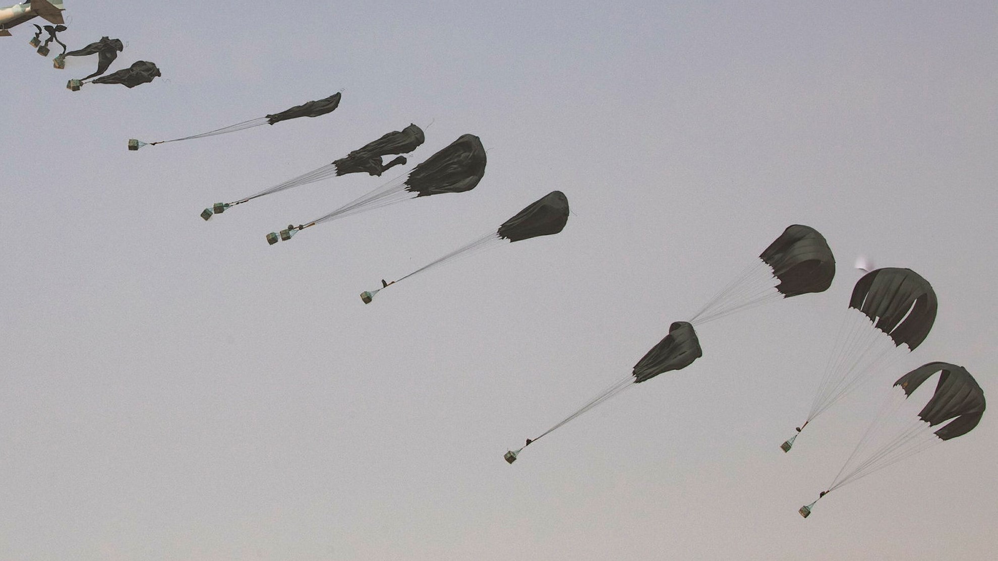 An Omani C130 transport aircraft drops parachuted supplies during the Fire Power Demonstration in 2021 CREDIT Crown Copyright